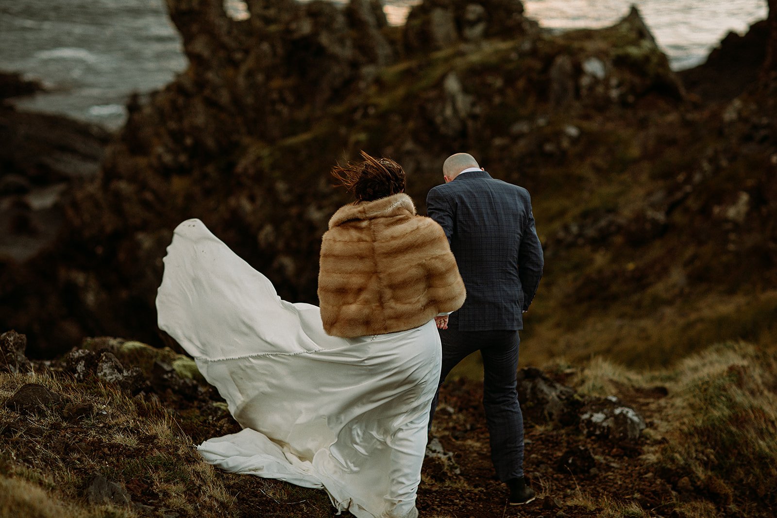 A Private Multi-Area Iceland Elopement by Steph Zakas Photography with wedding couple at sea cliff