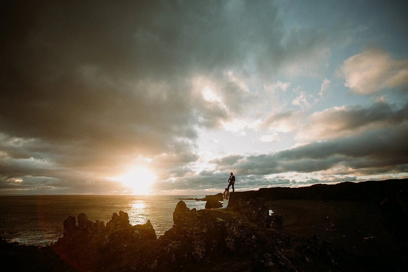 A Private Multi-Area Iceland Elopement by Steph Zakas Photography with wedding couple at sea cliff