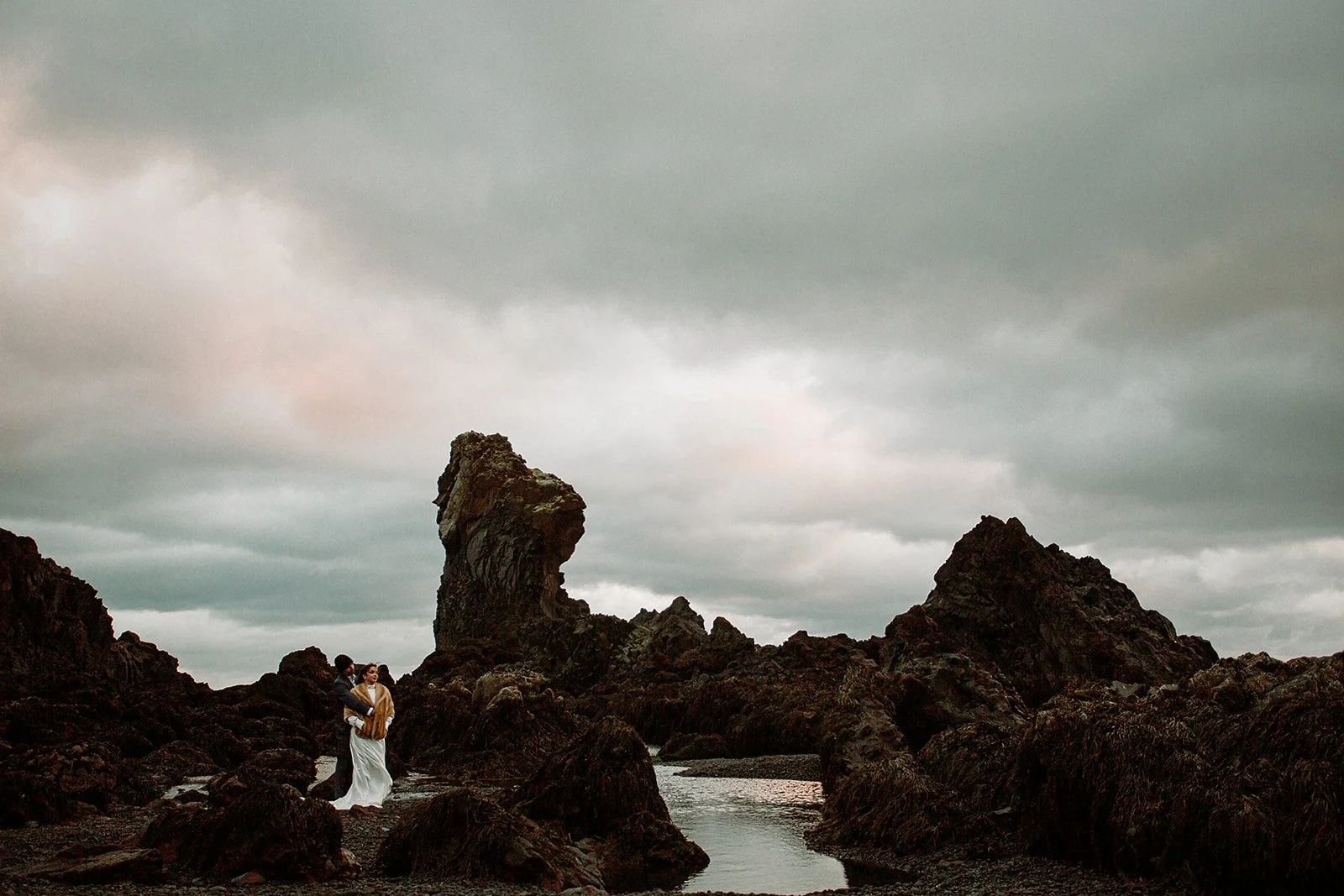 A Private Multi-Area Iceland Elopement by Steph Zakas Photography with wedding couple at sea cliff