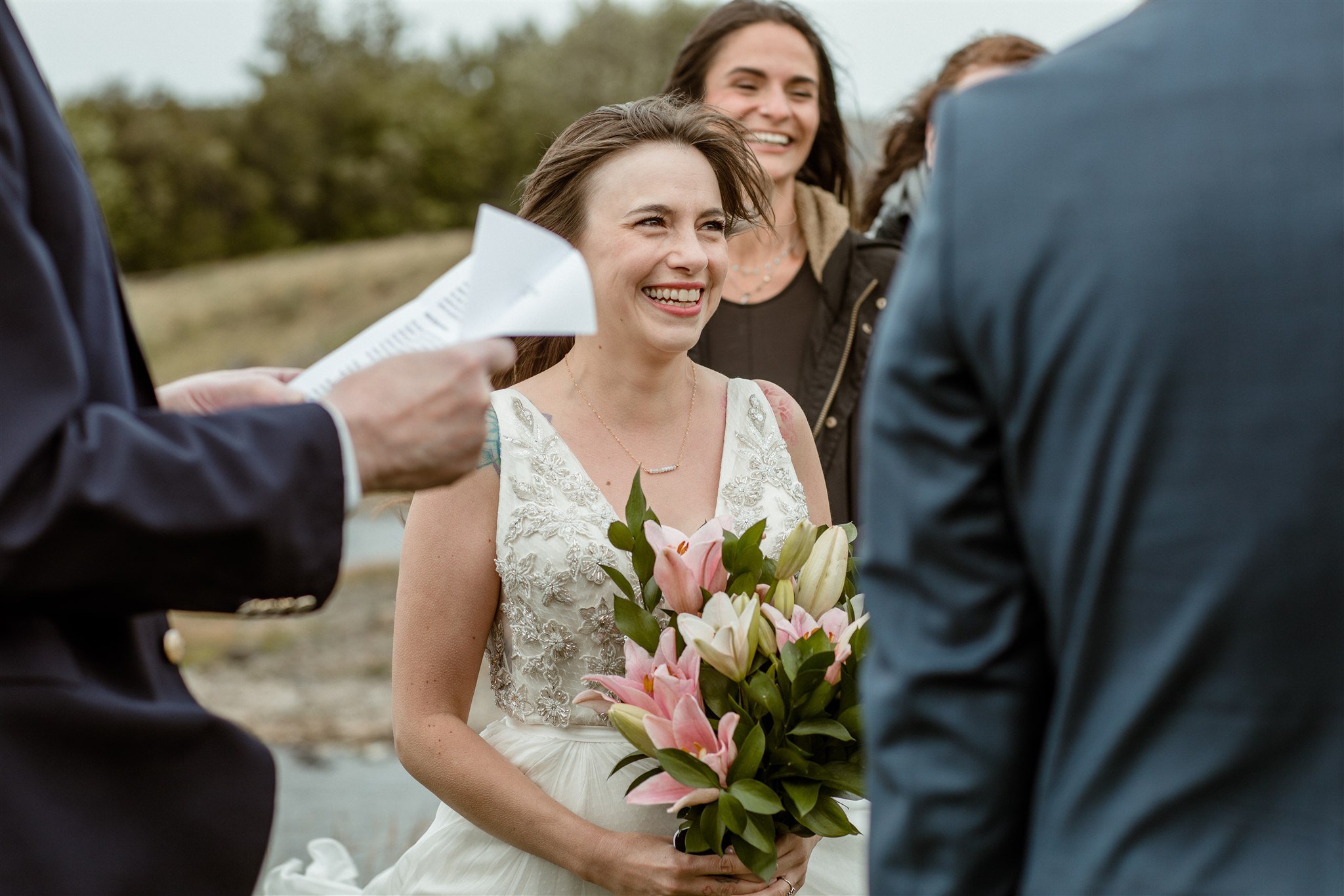  A Private Lake Iceland Elopement Starting in Reykjavík with Guests — at the private ceremony on a private lake with their guests surrounding them 