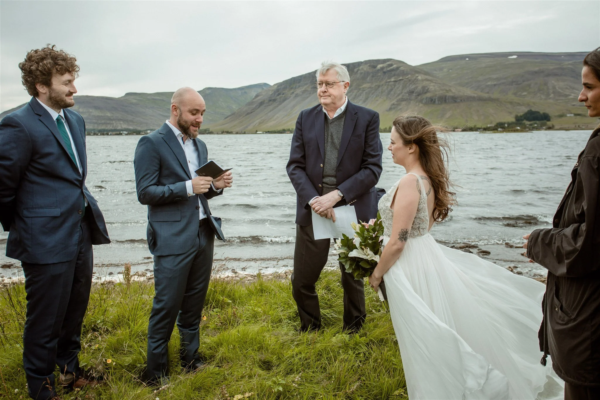  A Private Lake Iceland Elopement Starting in Reykjavík with Guests — at the private ceremony on a private lake with their guests surrounding them 