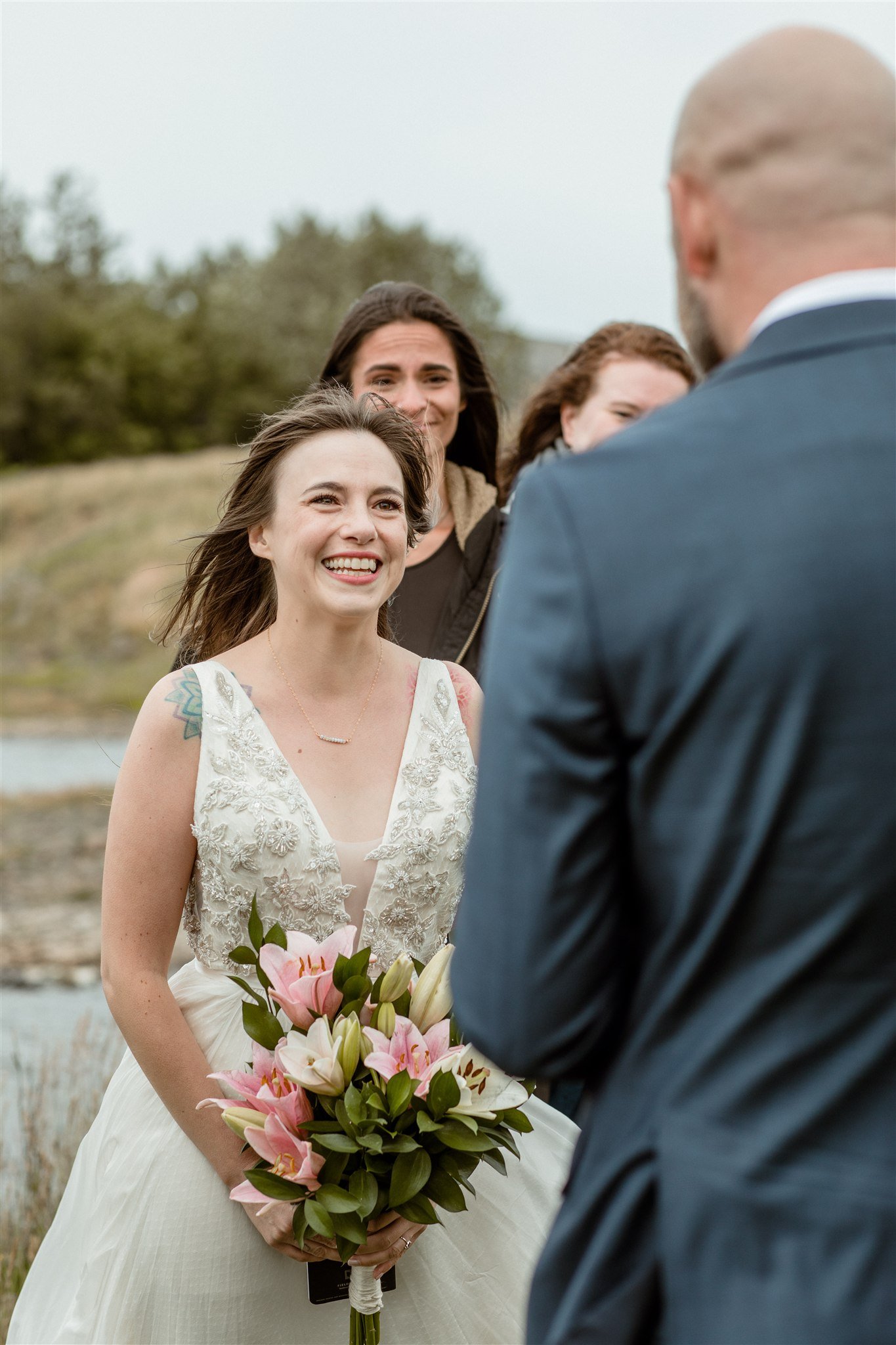  A Private Lake Iceland Elopement Starting in Reykjavík with Guests — at the private ceremony on a private lake with their guests surrounding them 