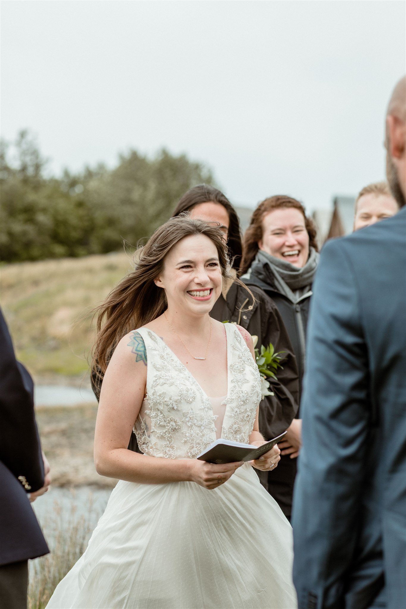  A Private Lake Iceland Elopement Starting in Reykjavík with Guests — at the private ceremony on a private lake with their guests surrounding them 