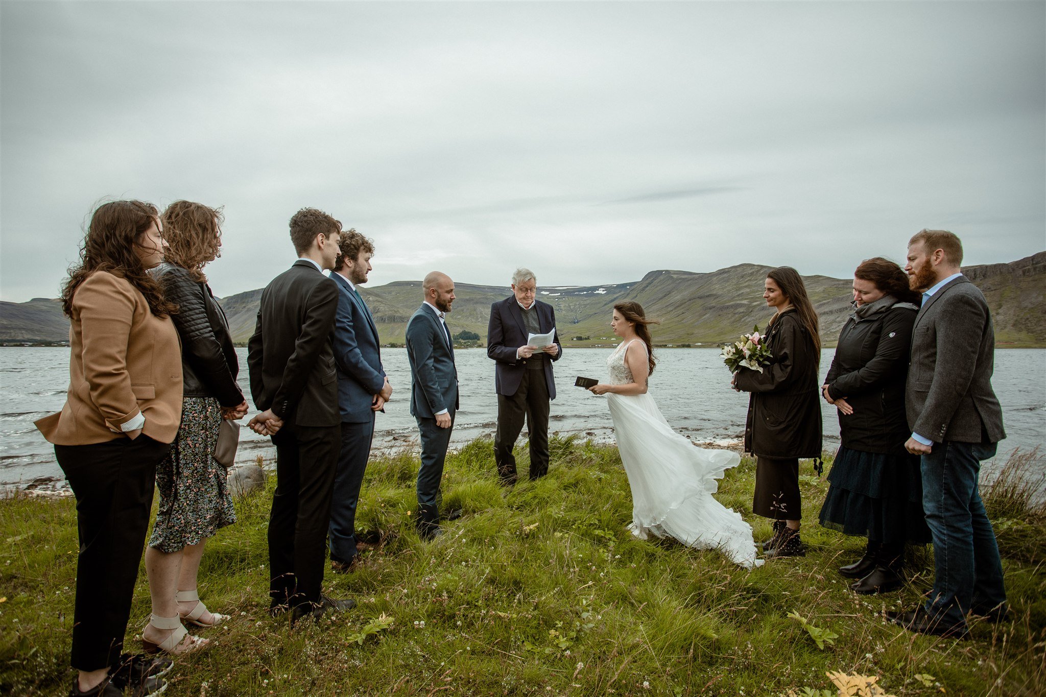  A Private Lake Iceland Elopement Starting in Reykjavík with Guests — at the private ceremony on a private lake with their guests surrounding them 