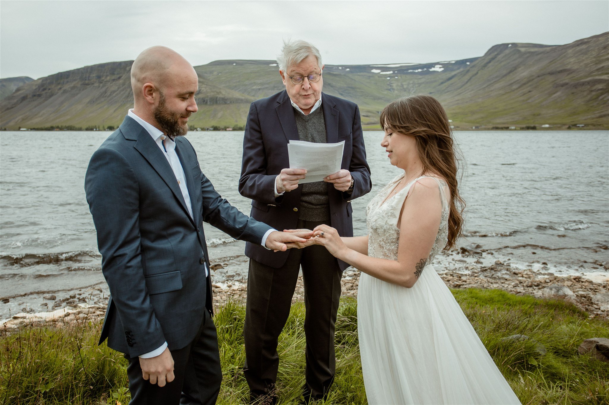  A Private Lake Iceland Elopement Starting in Reykjavík with Guests — at the private ceremony on a private lake with their guests surrounding them 