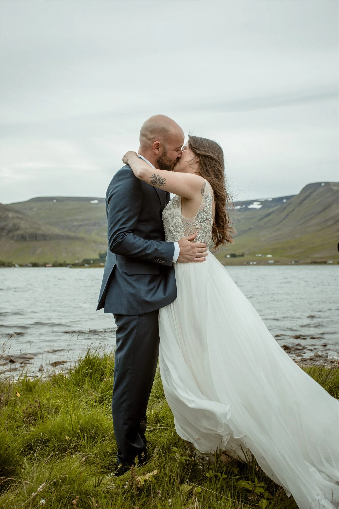  A Private Lake Iceland Elopement Starting in Reykjavík with Guests — couple first kiss at ceremony  