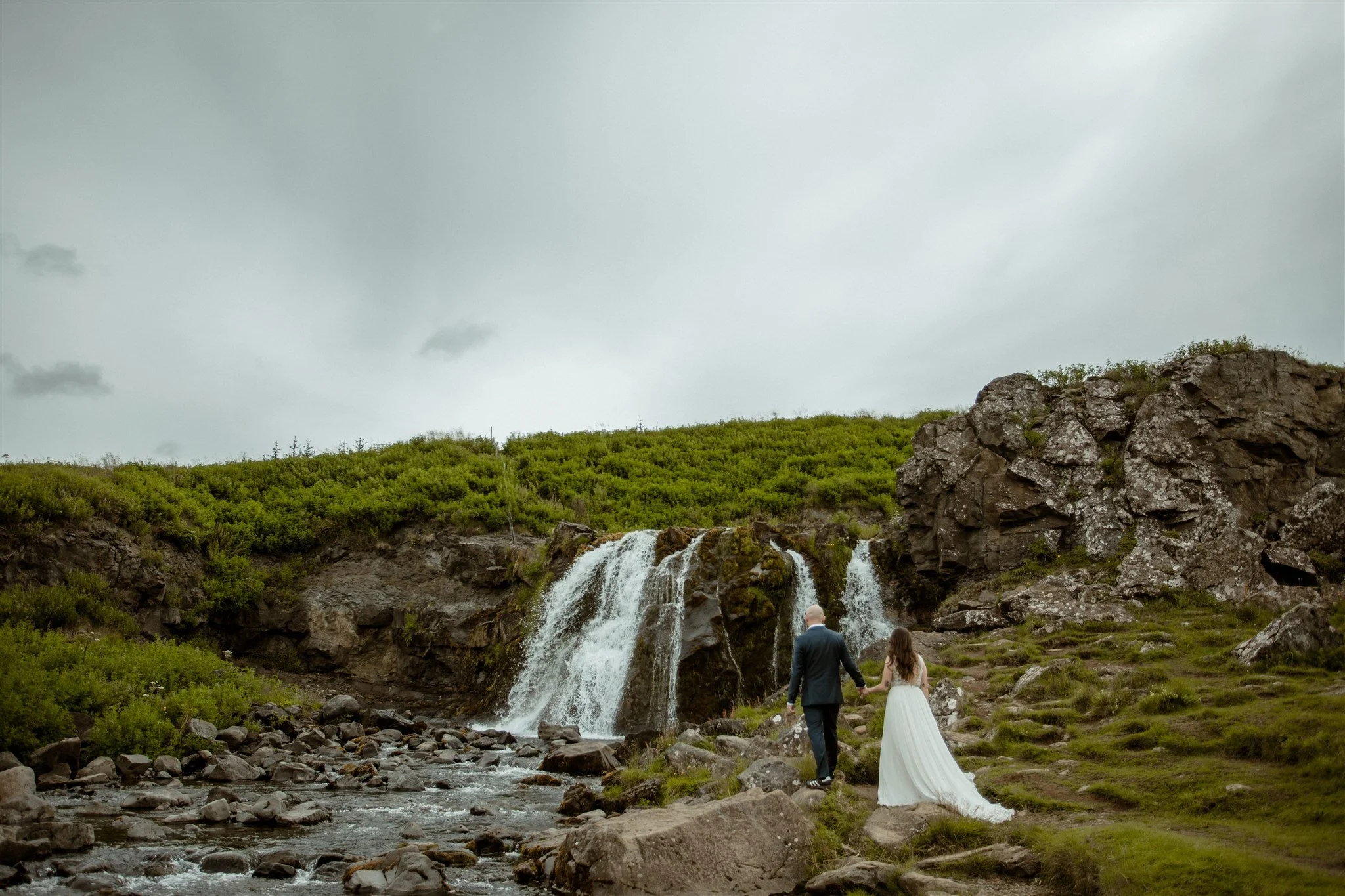  A Private Lake Iceland Elopement Starting in Reykjavík with Guests by Iceland elopement photographer &amp; planner Steph Zakas — couple on an adventure for elopement photos at a private waterfall 