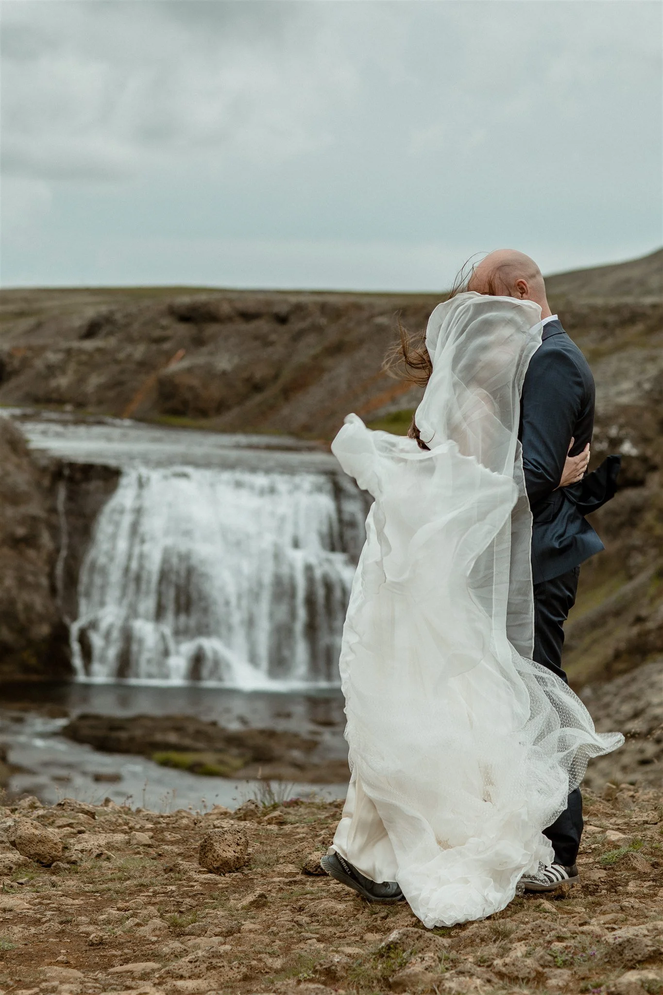  A Private Lake Iceland Elopement Starting in Reykjavík with Guests by Iceland elopement photographer &amp; planner Steph Zakas — couple on an adventure for elopement photos at a private waterfall 