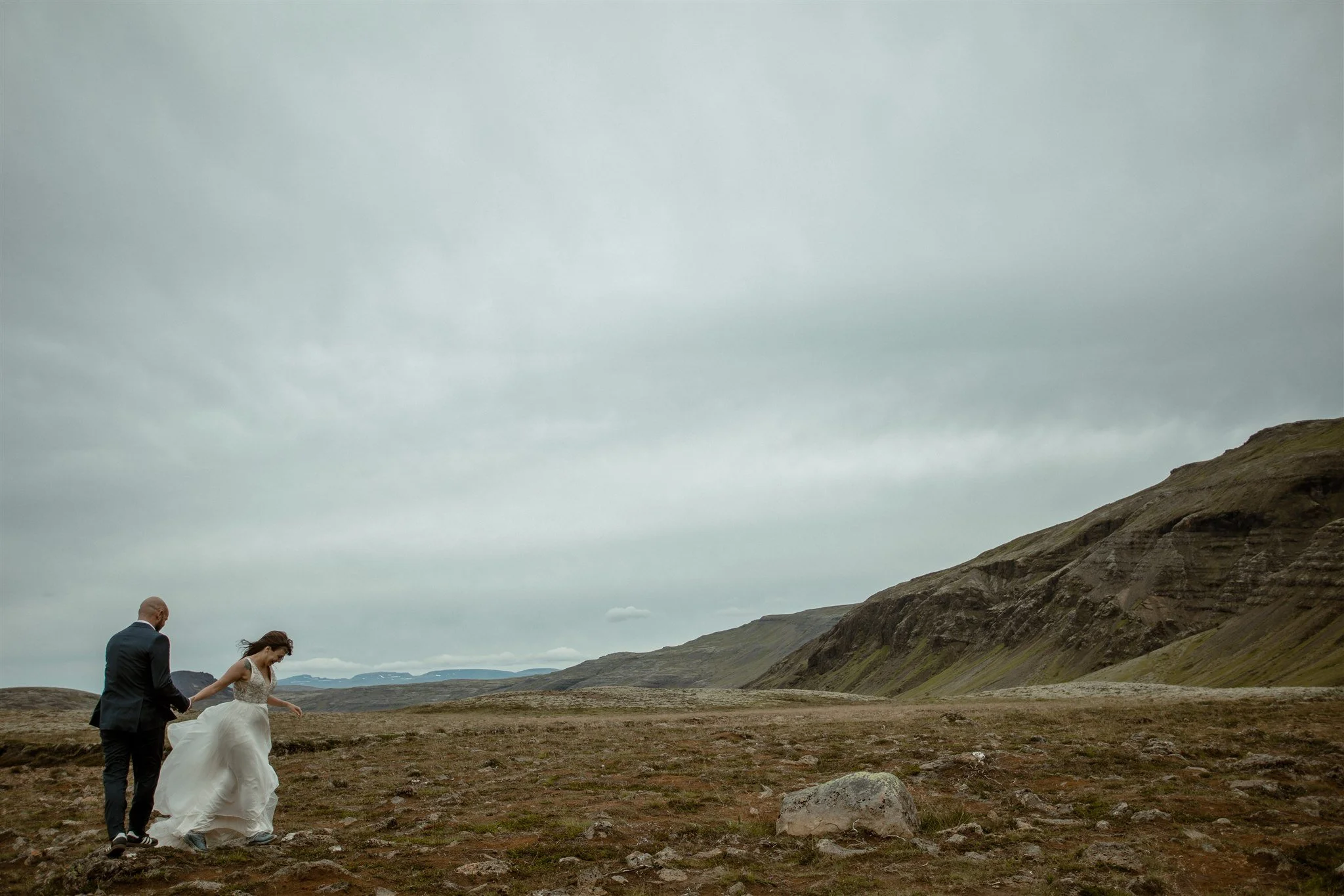  A Private Lake Iceland Elopement Starting in Reykjavík with Guests by Iceland elopement photographer &amp; planner Steph Zakas — couple on an adventure for elopement photos at a volcanic area 