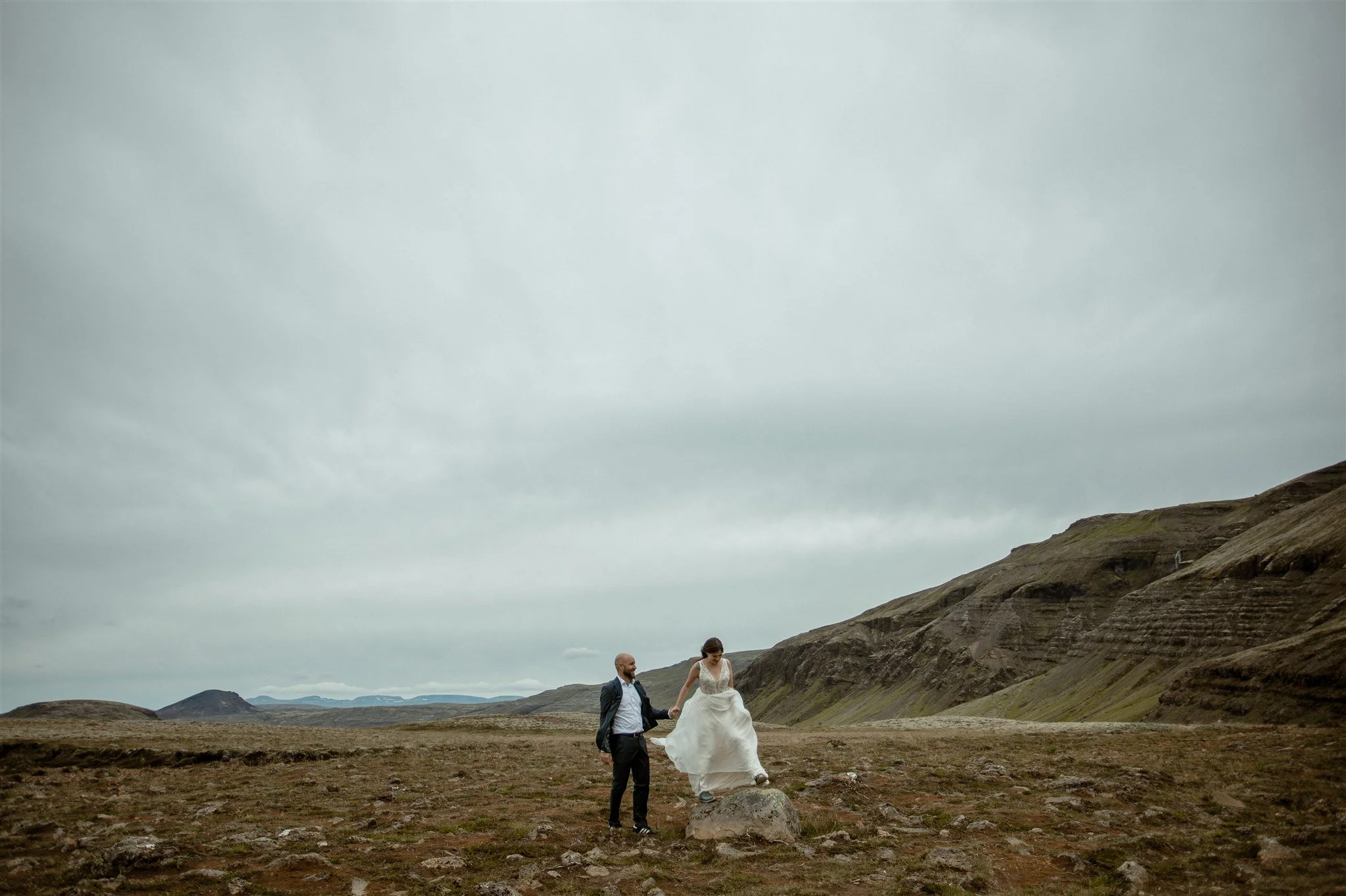  A Private Lake Iceland Elopement Starting in Reykjavík with Guests by Iceland elopement photographer &amp; planner Steph Zakas — couple on an adventure for elopement photos at a volcanic area 