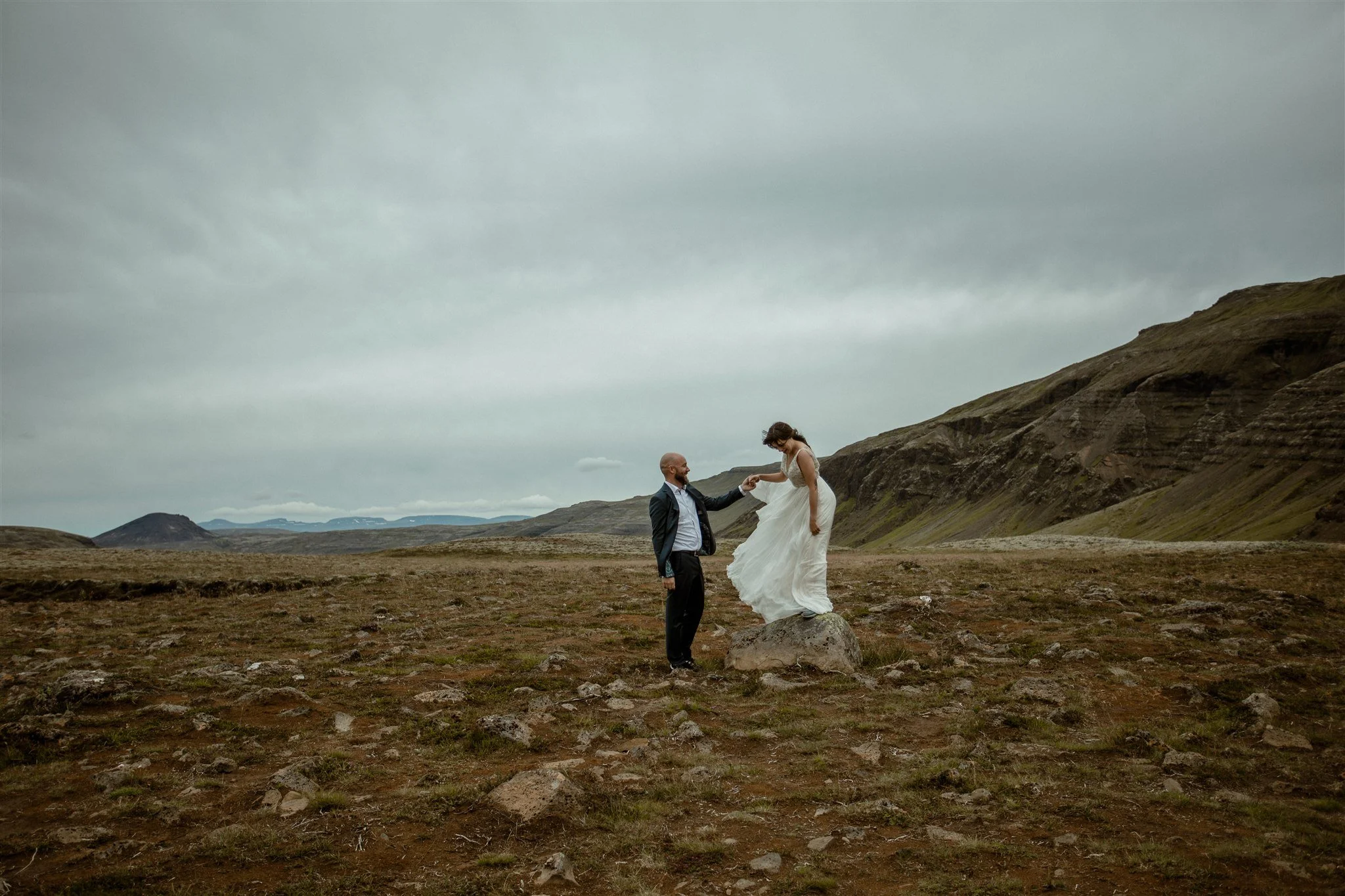  A Private Lake Iceland Elopement Starting in Reykjavík with Guests by Iceland elopement photographer &amp; planner Steph Zakas — couple on an adventure for elopement photos at a volcanic area 