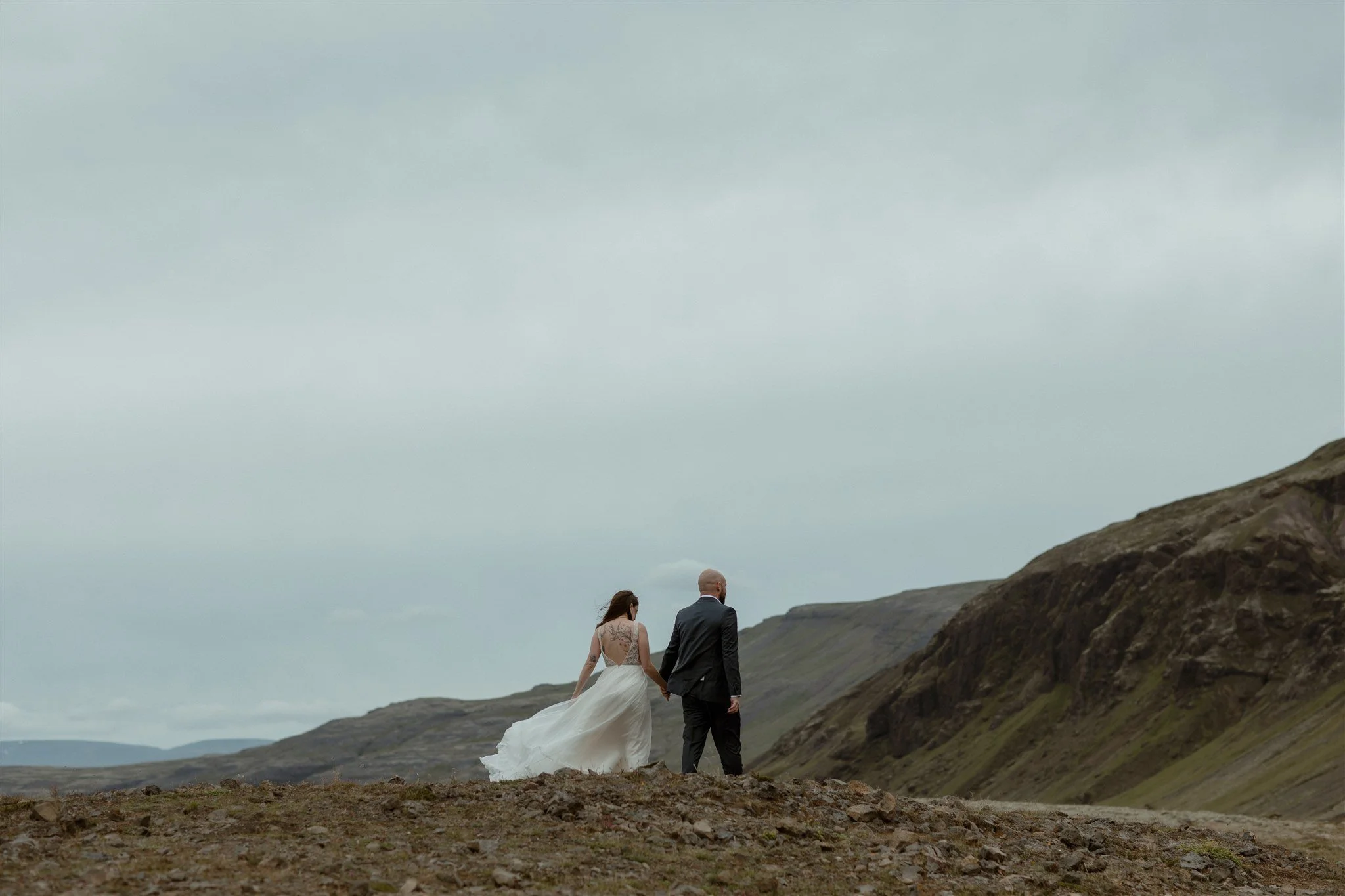  A Private Lake Iceland Elopement Starting in Reykjavík with Guests by Iceland elopement photographer &amp; planner Steph Zakas — couple on an adventure for elopement photos at a volcanic area 