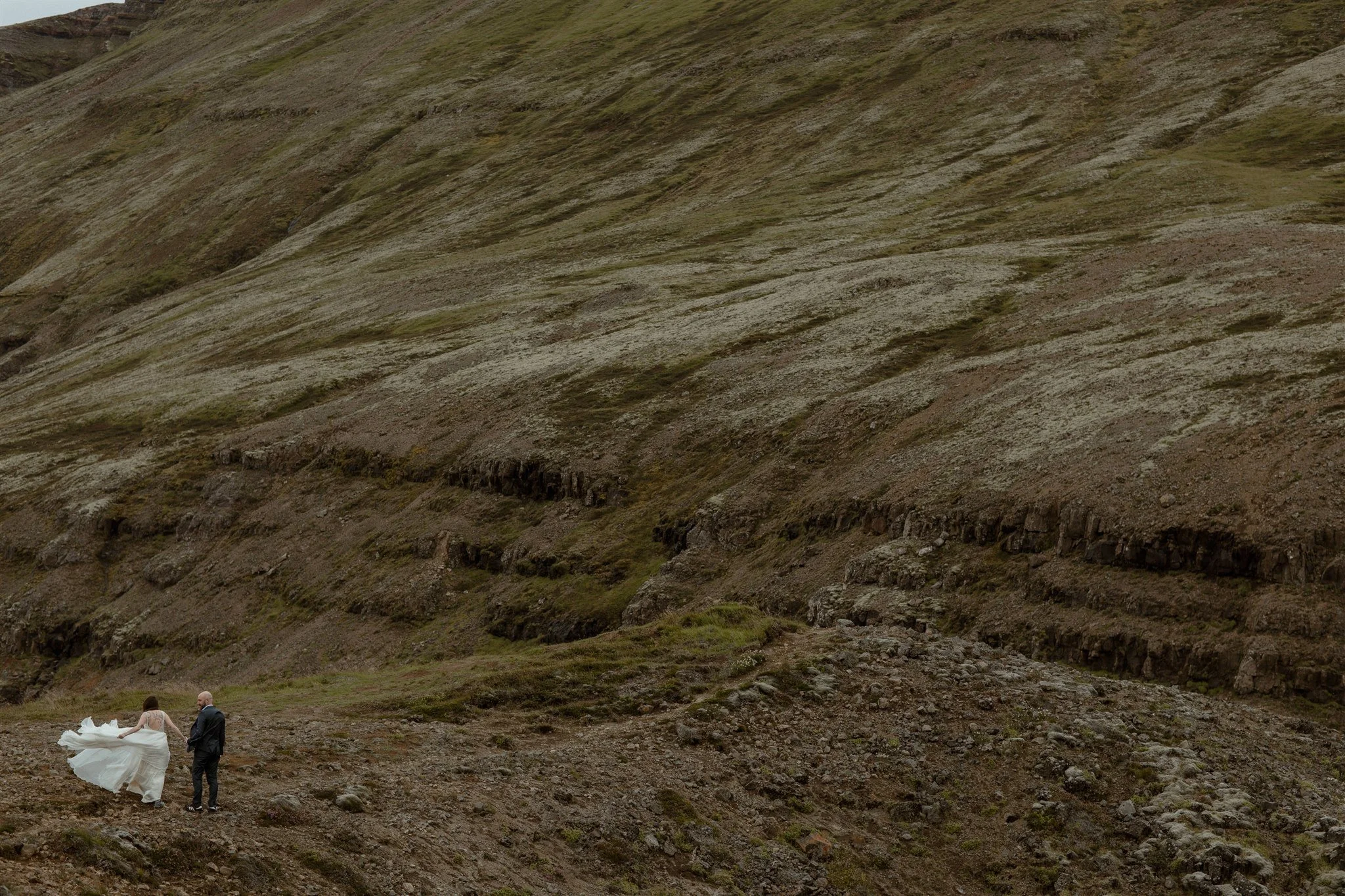 A Private Lake Iceland Elopement Starting in Reykjavík with Guests by Iceland elopement photographer &amp; planner Steph Zakas — couple on an adventure for elopement photos at a volcanic area 