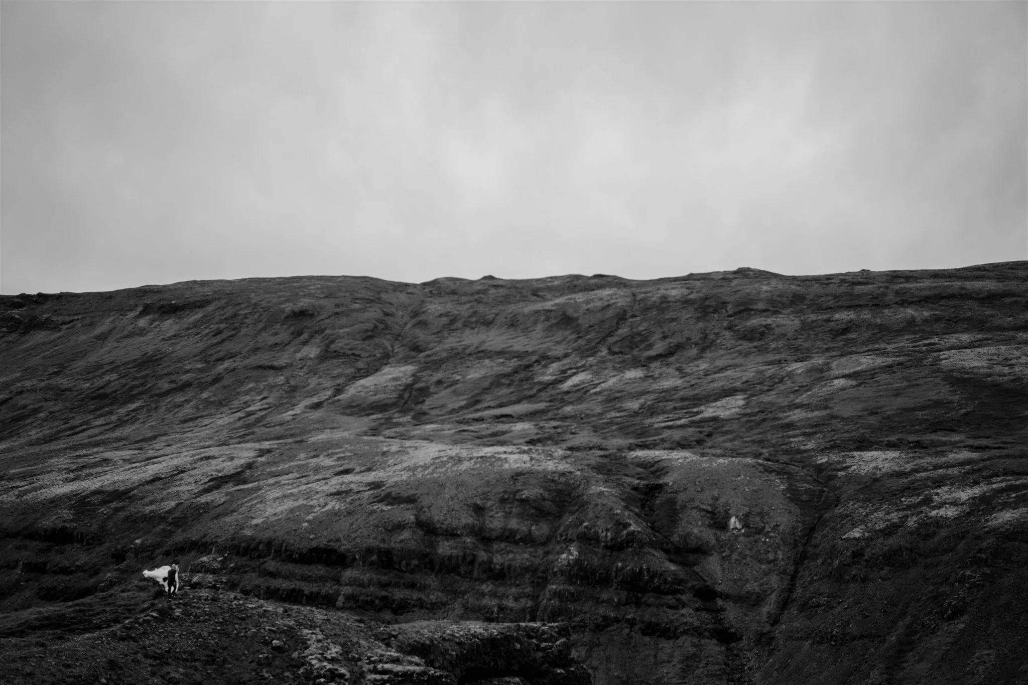  A Private Lake Iceland Elopement Starting in Reykjavík with Guests by Iceland elopement photographer &amp; planner Steph Zakas — couple on an adventure for elopement photos at a volcanic area 
