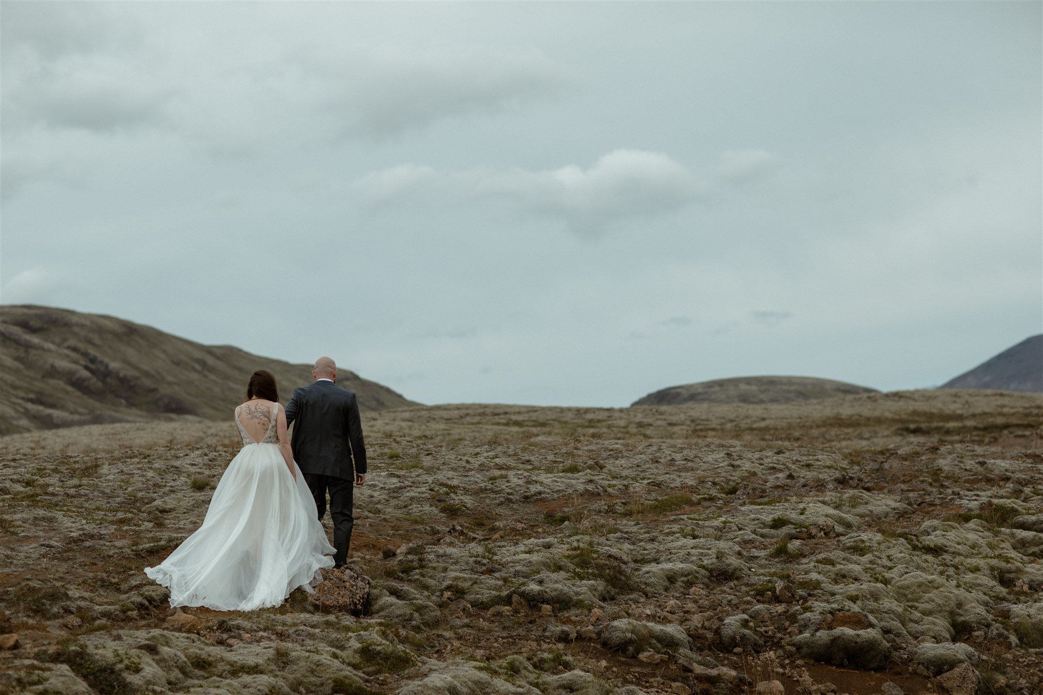  A Private Lake Iceland Elopement Starting in Reykjavík with Guests by Iceland elopement photographer &amp; planner Steph Zakas — couple on an adventure for elopement photos at a volcanic area 