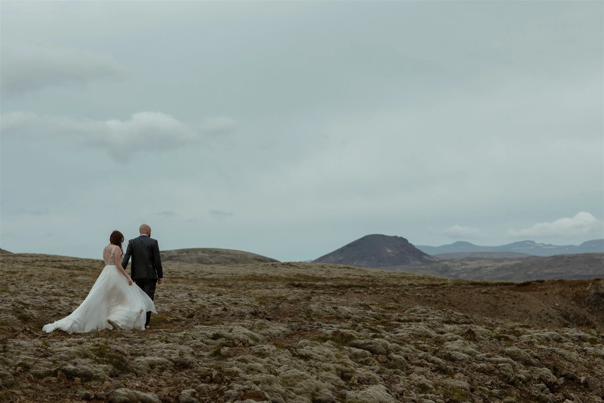  A Private Lake Iceland Elopement Starting in Reykjavík with Guests by Iceland elopement photographer &amp; planner Steph Zakas — couple on an adventure for elopement photos at a volcanic area 