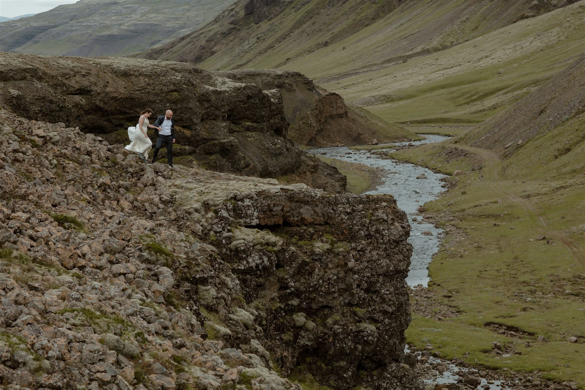  A Private Lake Iceland Elopement Starting in Reykjavík with Guests by Iceland elopement photographer &amp; planner Steph Zakas — couple on an adventure for elopement photos at a volcanic area 