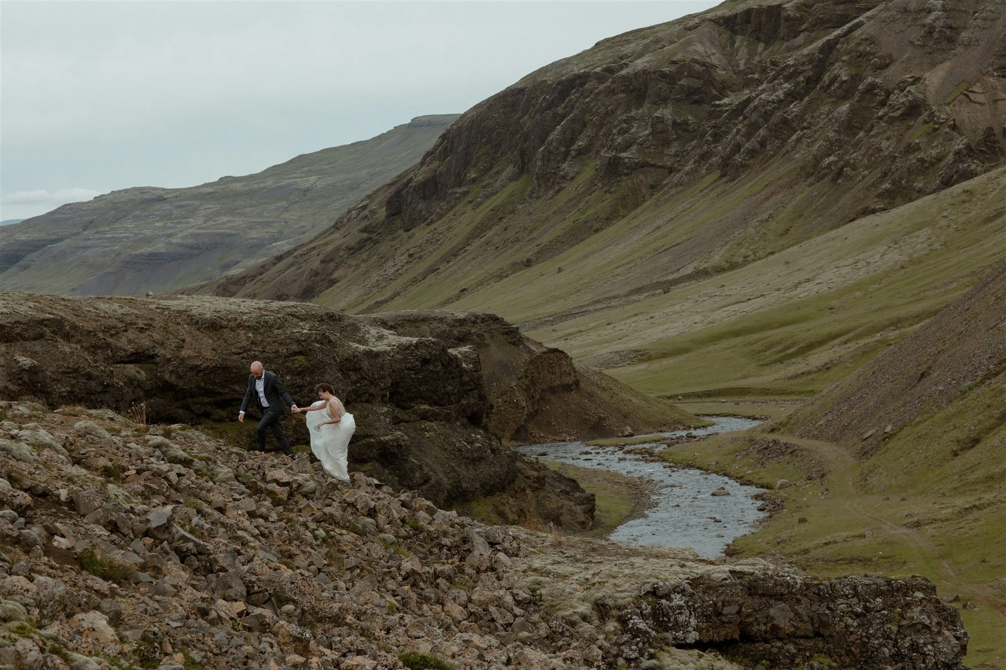  A Private Lake Iceland Elopement Starting in Reykjavík with Guests by Iceland elopement photographer &amp; planner Steph Zakas — couple on an adventure for elopement photos at a volcanic area 