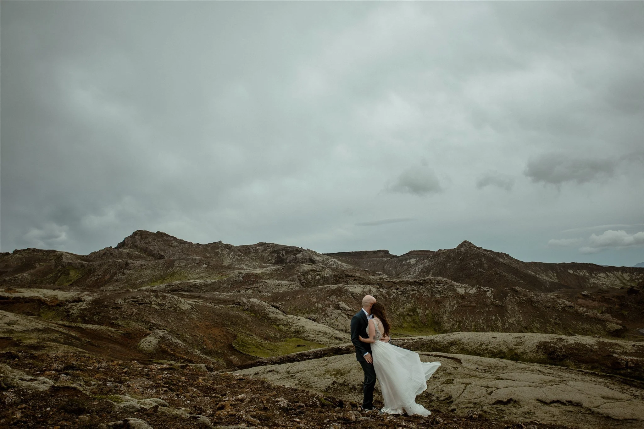  A Private Lake Iceland Elopement Starting in Reykjavík with Guests by Iceland elopement photographer &amp; planner Steph Zakas — couple on an adventure for elopement photos at a volcanic area  
