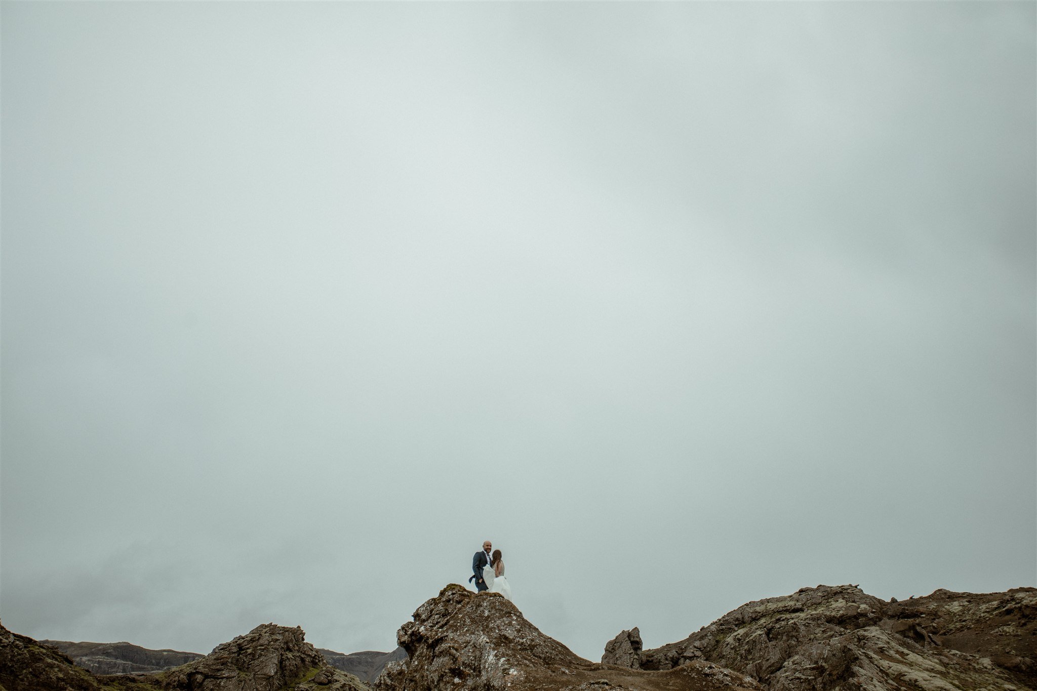  A Private Lake Iceland Elopement Starting in Reykjavík with Guests by Iceland elopement photographer &amp; planner Steph Zakas — couple on an adventure for elopement photos at a volcanic area  