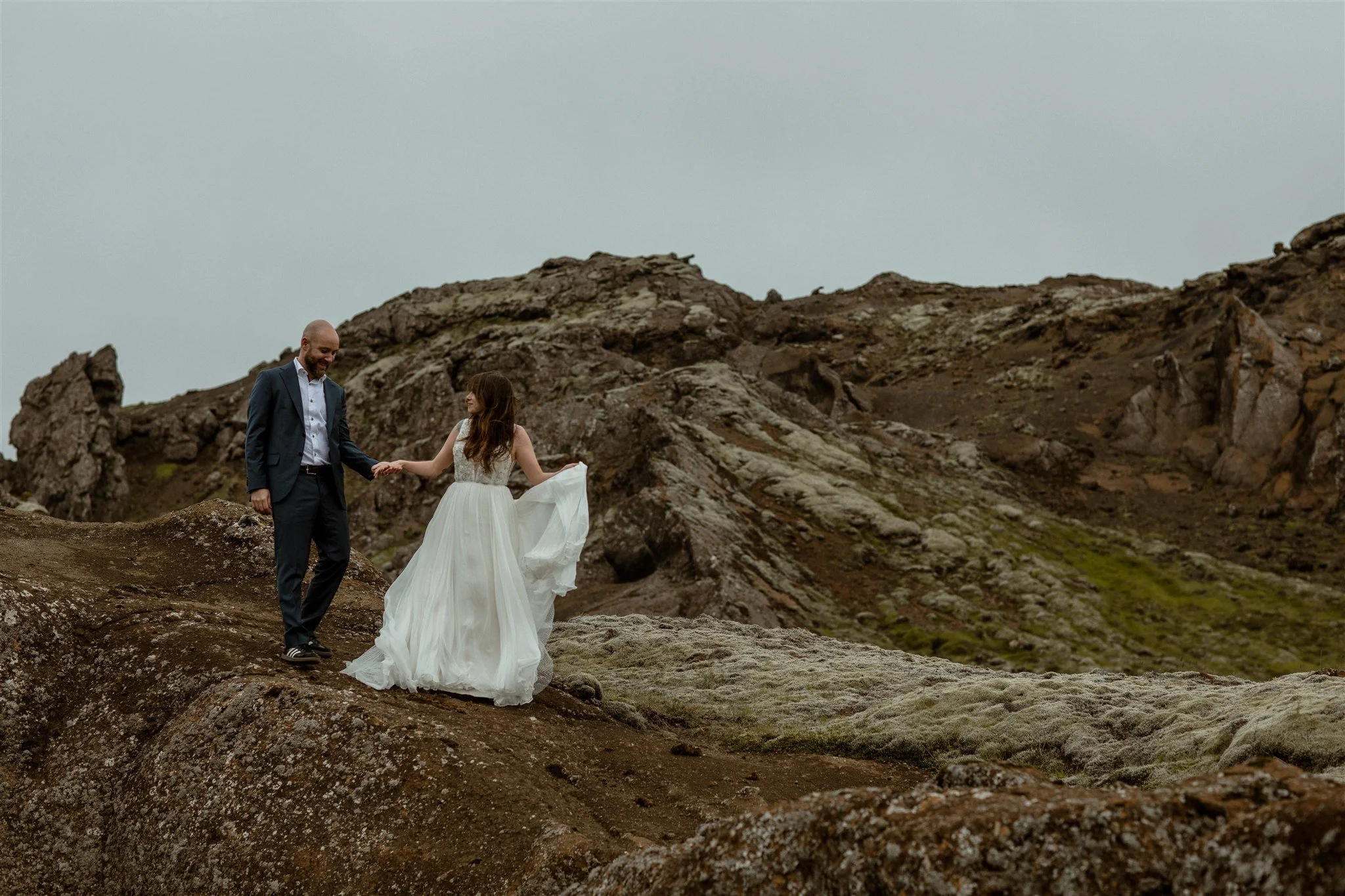  A Private Lake Iceland Elopement Starting in Reykjavík with Guests by Iceland elopement photographer &amp; planner Steph Zakas — couple on an adventure for elopement photos at a volcanic area  