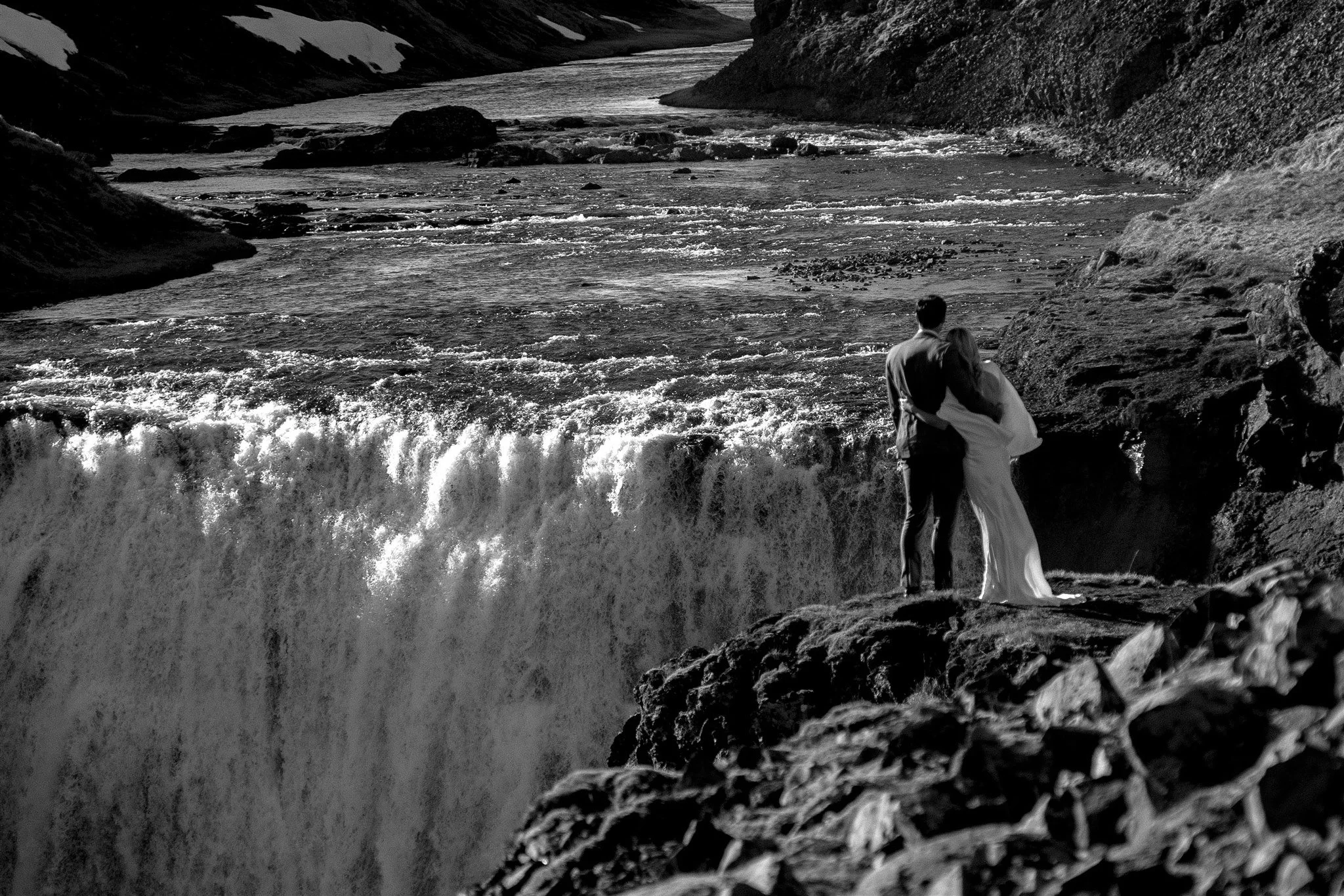 Lord of the Rings Inspired Iceland Engagement Photoshoot at waterfall — couple walking by mountains