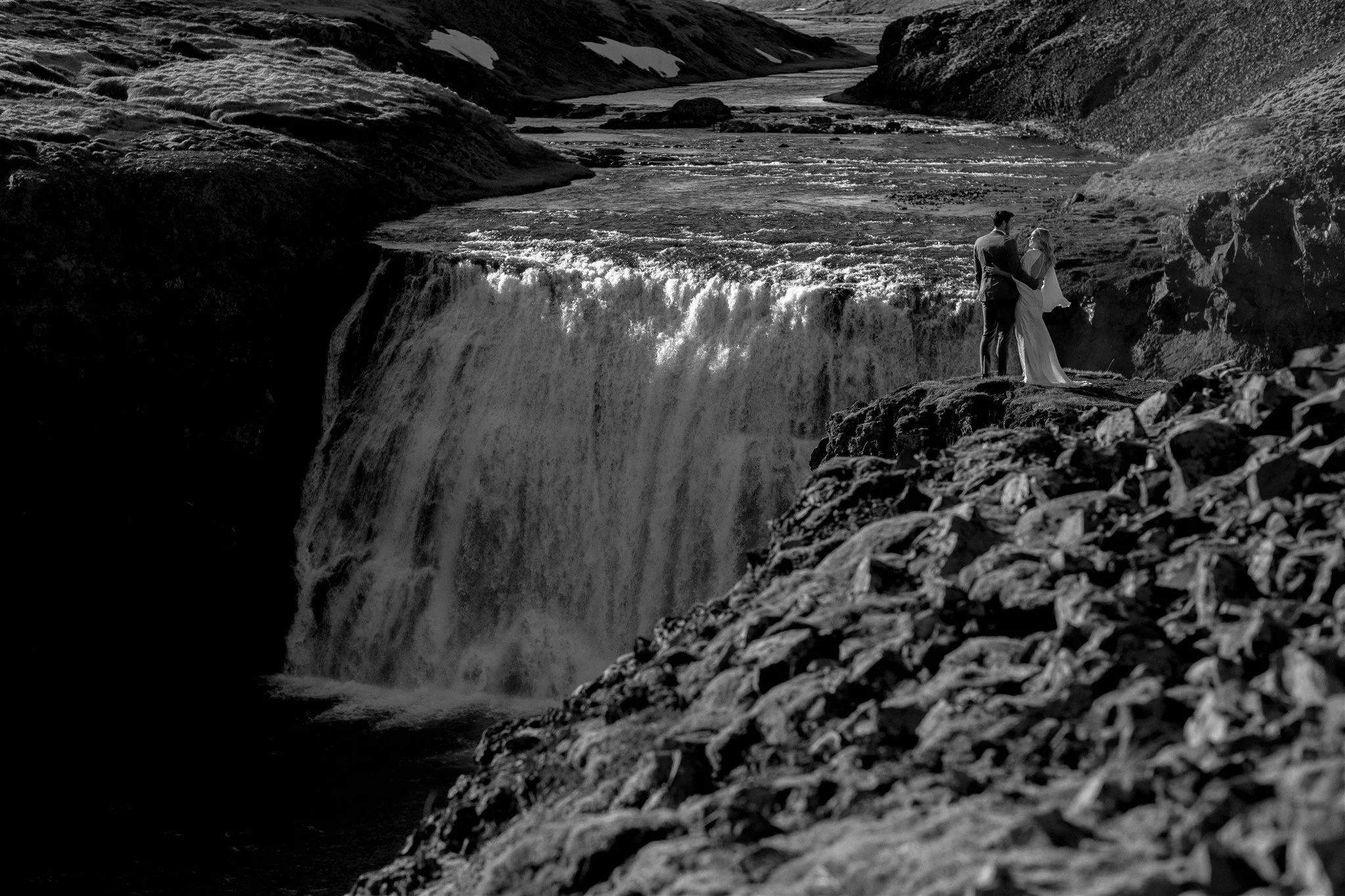 Lord of the Rings Inspired Iceland Engagement Photoshoot at waterfall — couple walking by mountains