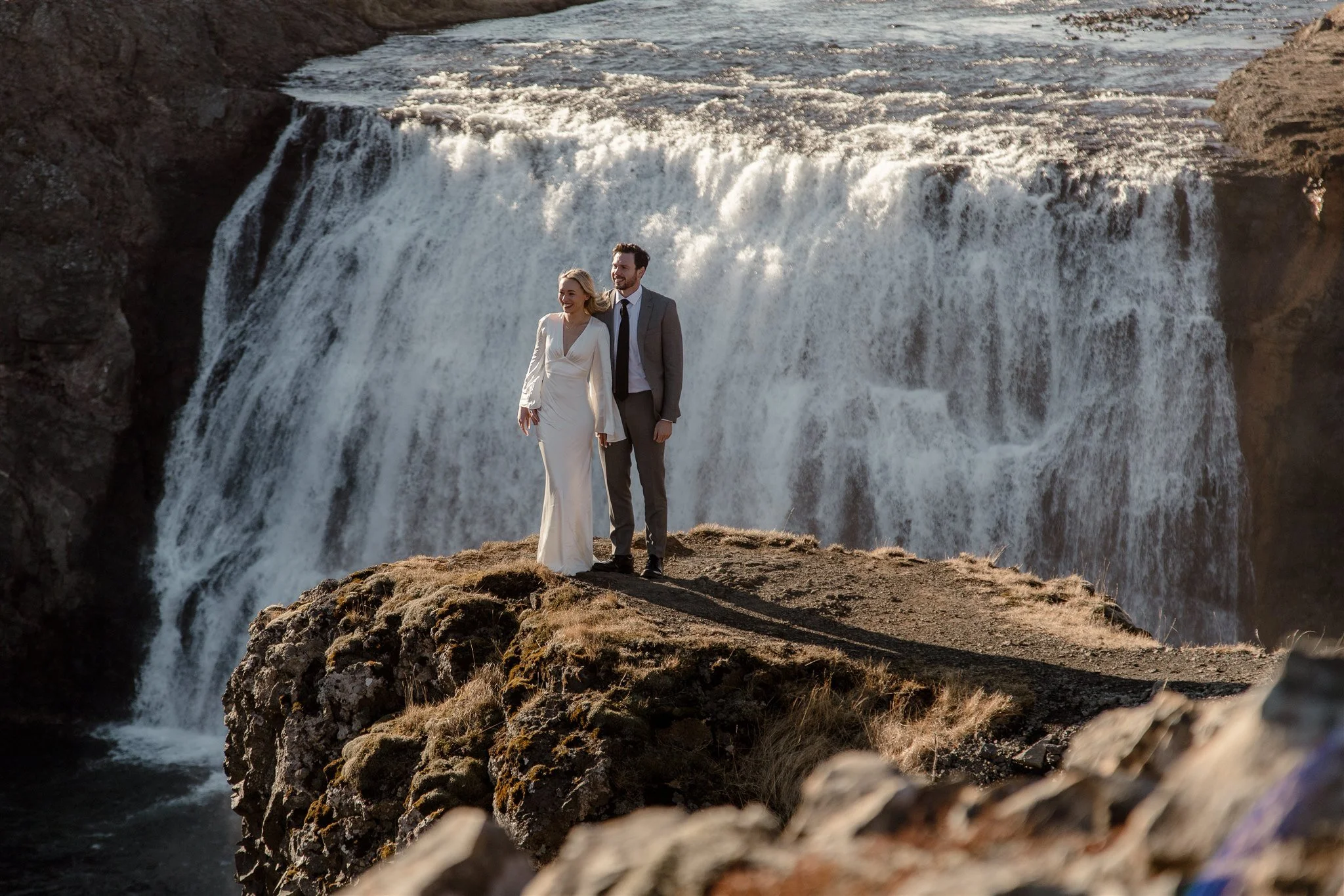 Lord of the Rings Inspired Iceland Engagement Photoshoot at waterfall — couple walking by mountains