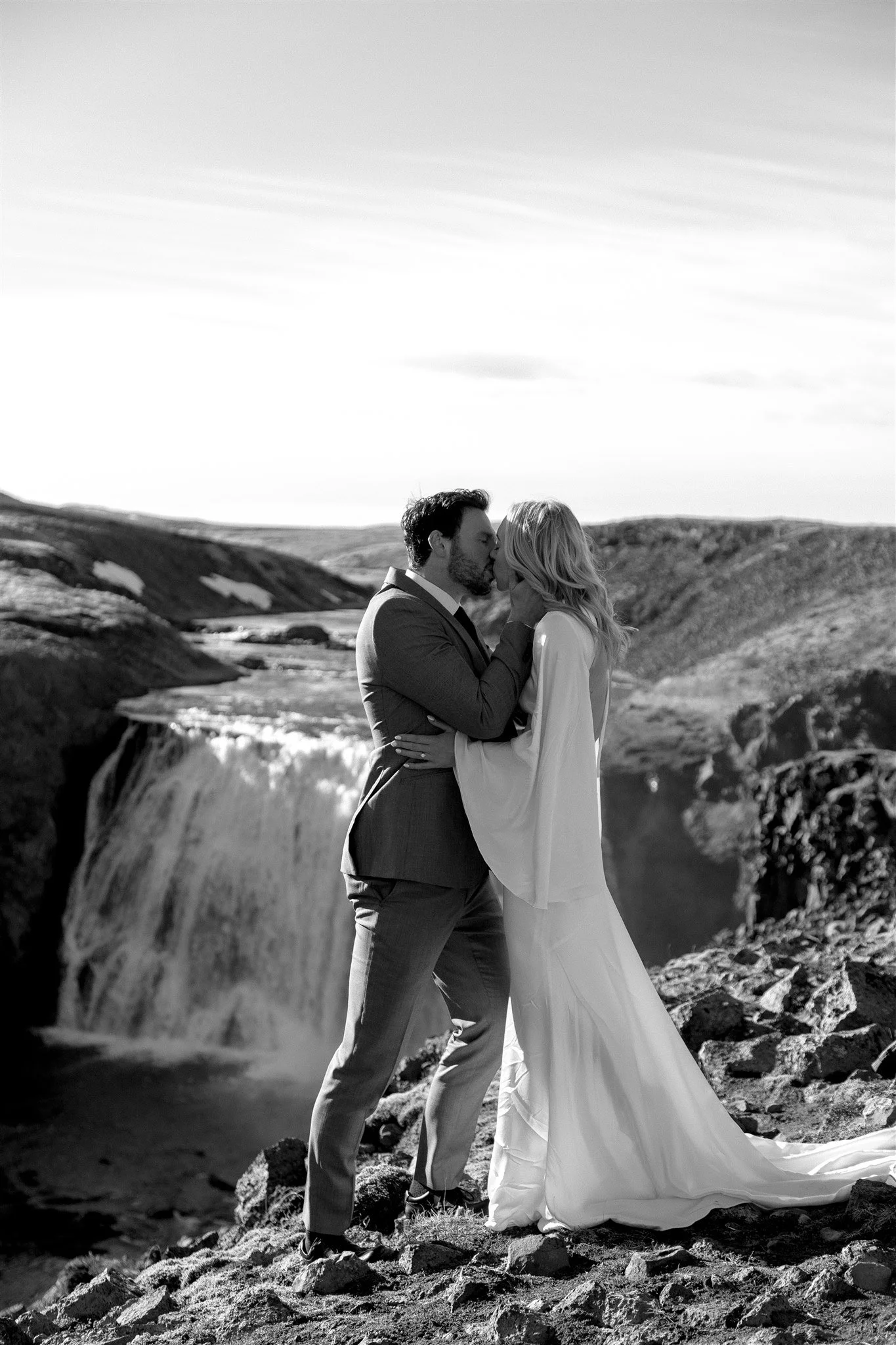 Lord of the Rings Inspired Iceland Engagement Photoshoot at waterfall — couple together with Arwen inspired dress