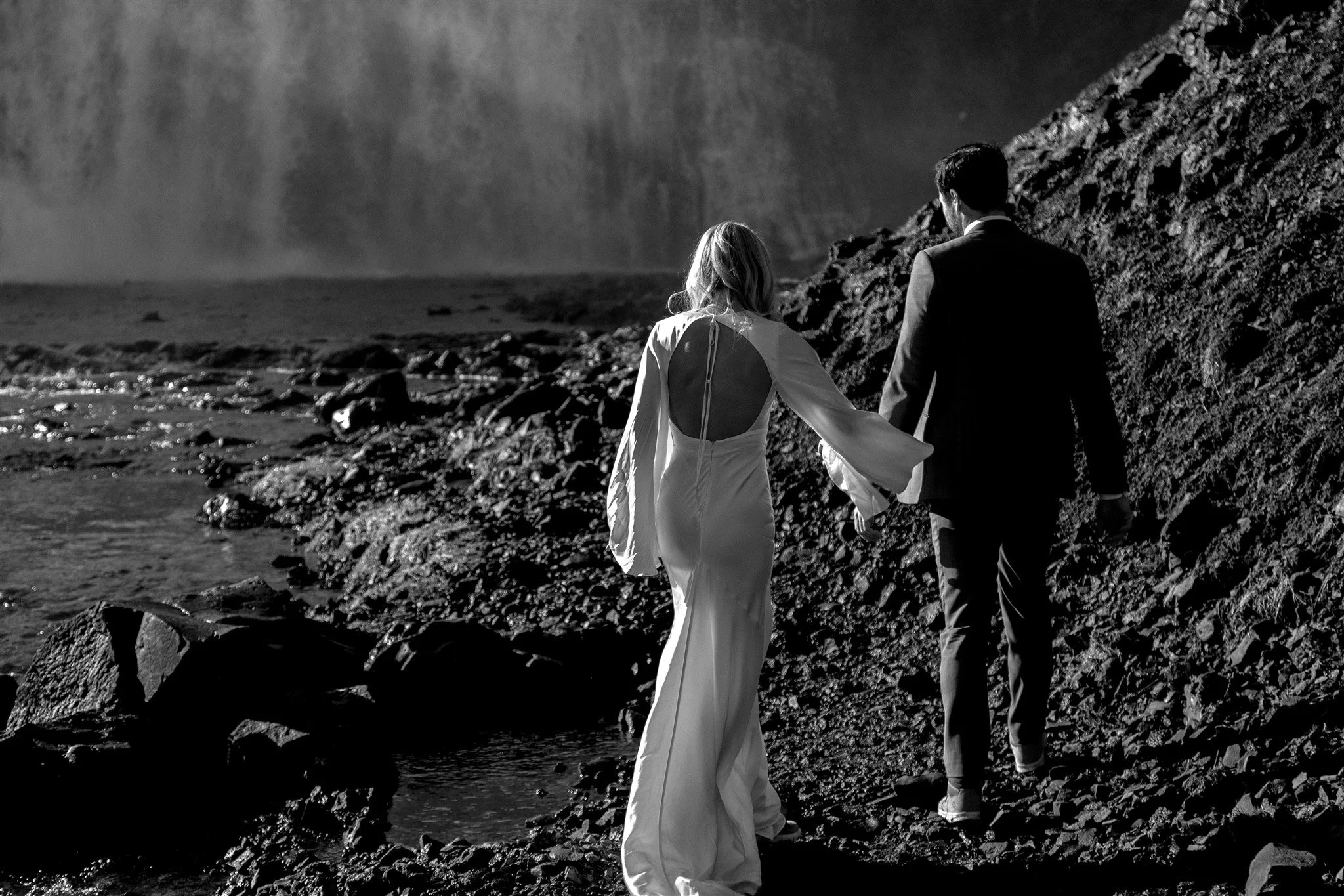 Lord of the Rings Inspired Iceland Engagement Photoshoot at waterfall — couple together with Arwen inspired dress