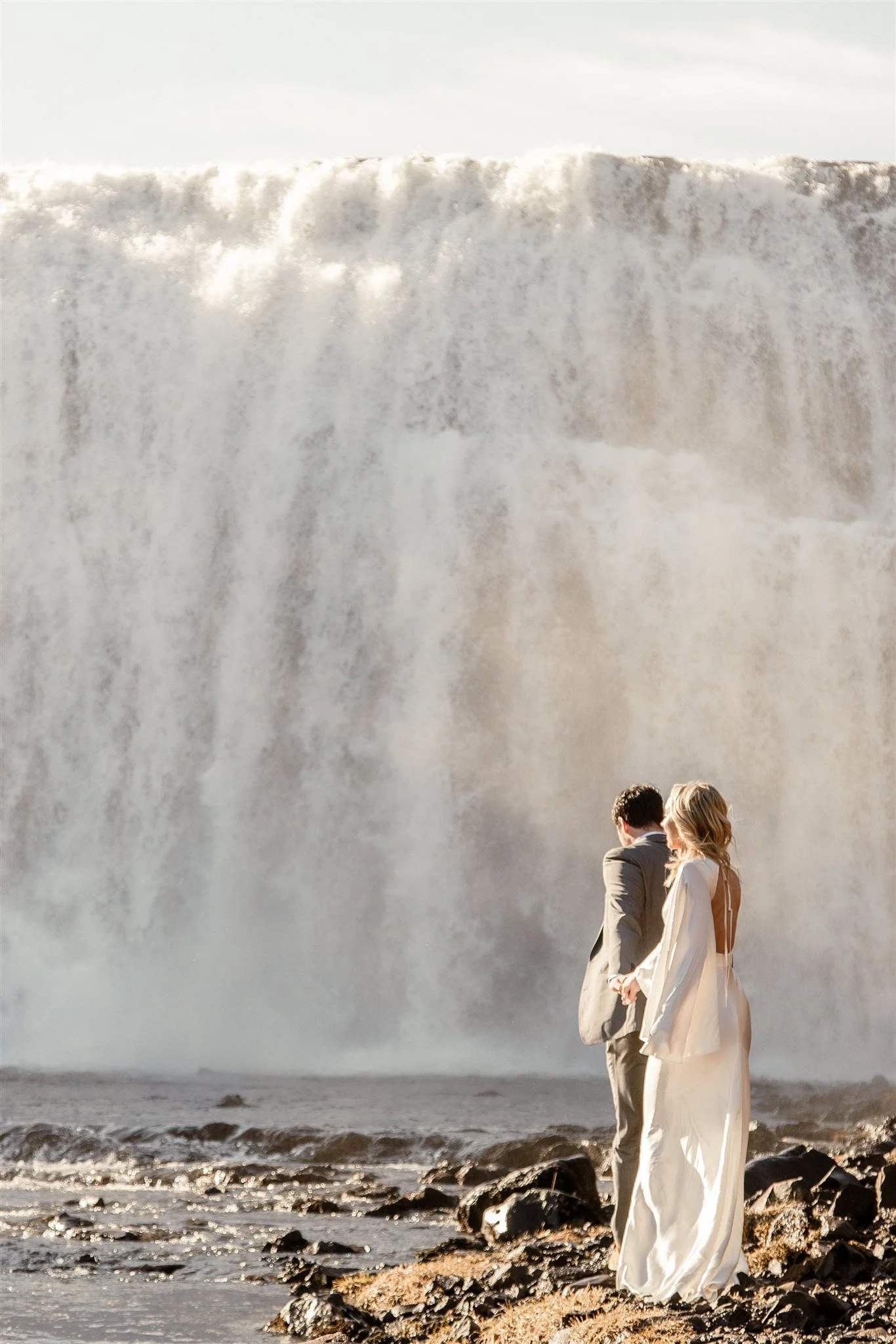 Lord of the Rings Inspired Iceland Engagement Photoshoot at waterfall — couple together with Arwen inspired dress