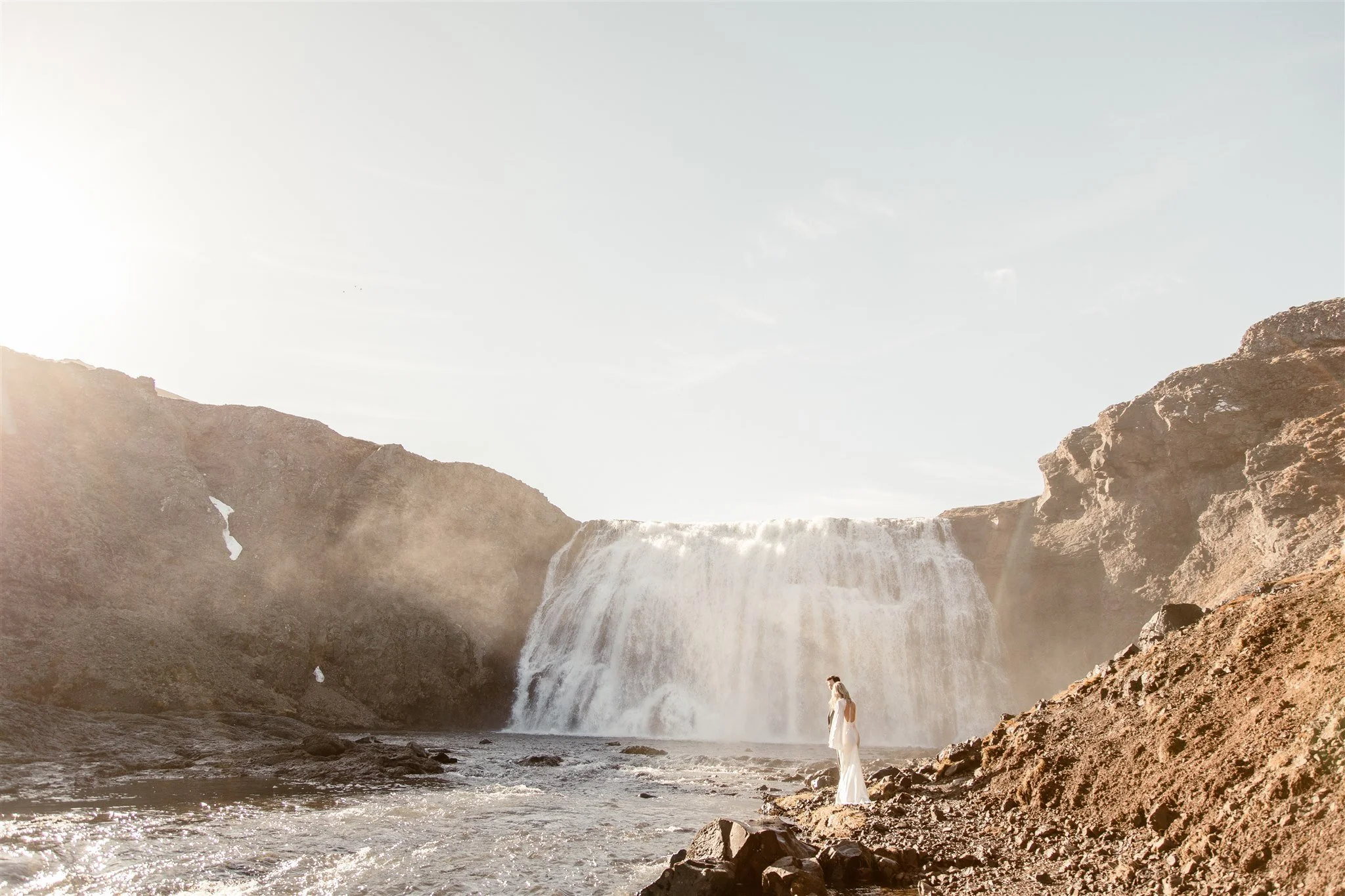 Lord of the Rings Inspired Iceland Engagement Photoshoot at waterfall — couple together with Arwen inspired dress
