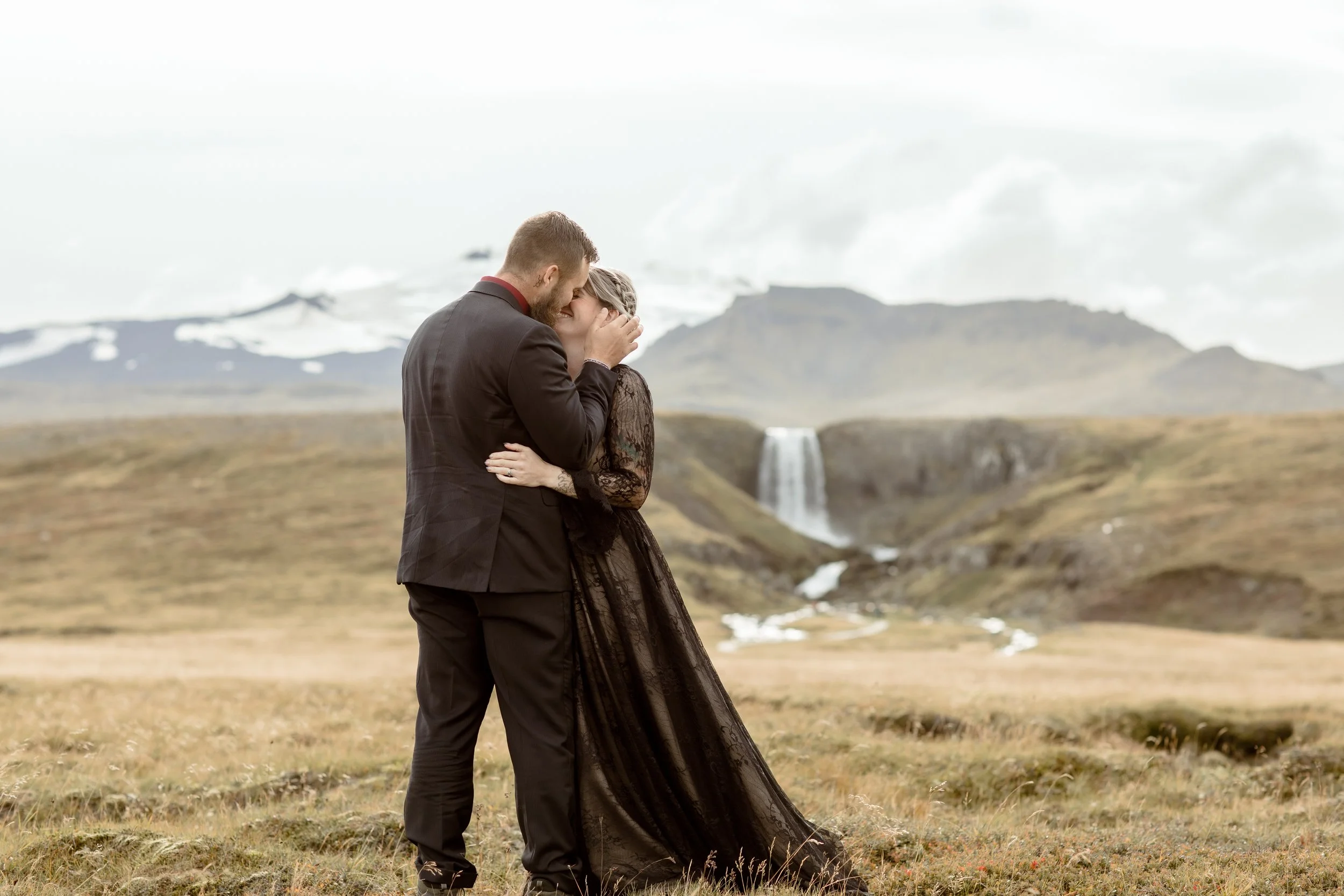 private iceland elopement at waterfall with black wedding dress by Iceland elopement photographer Steph zakas