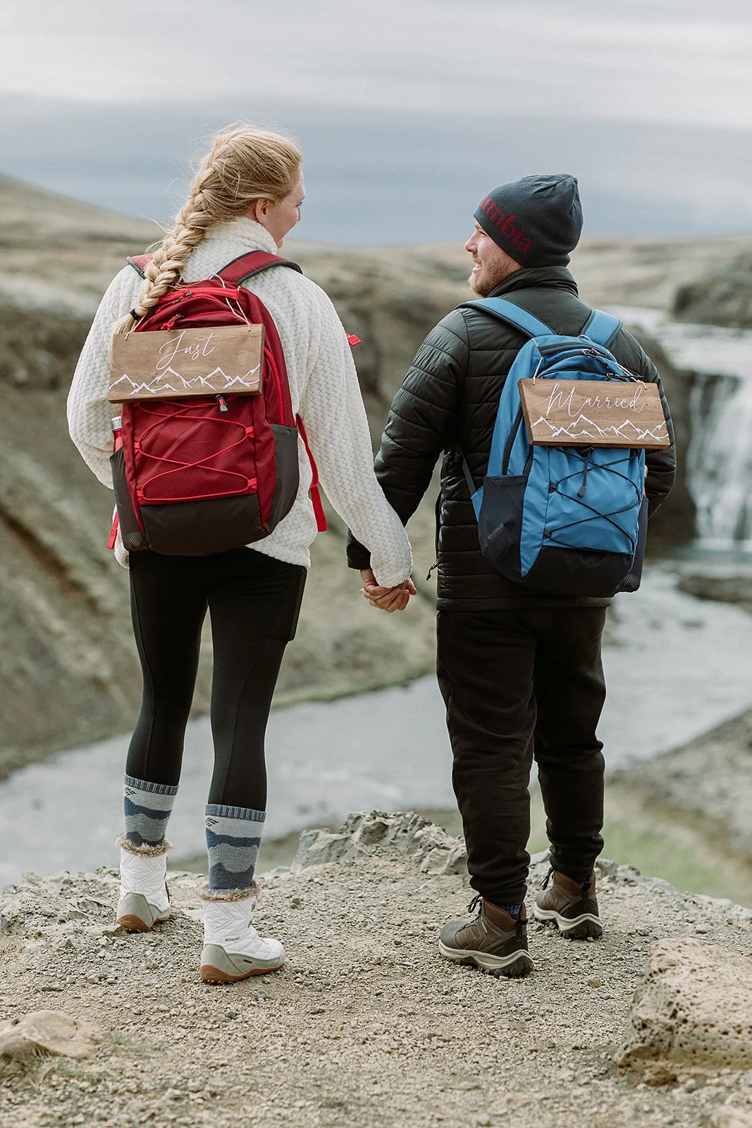 Iceland elopement adventure session post wedding with couple and wedding accessory backpacks