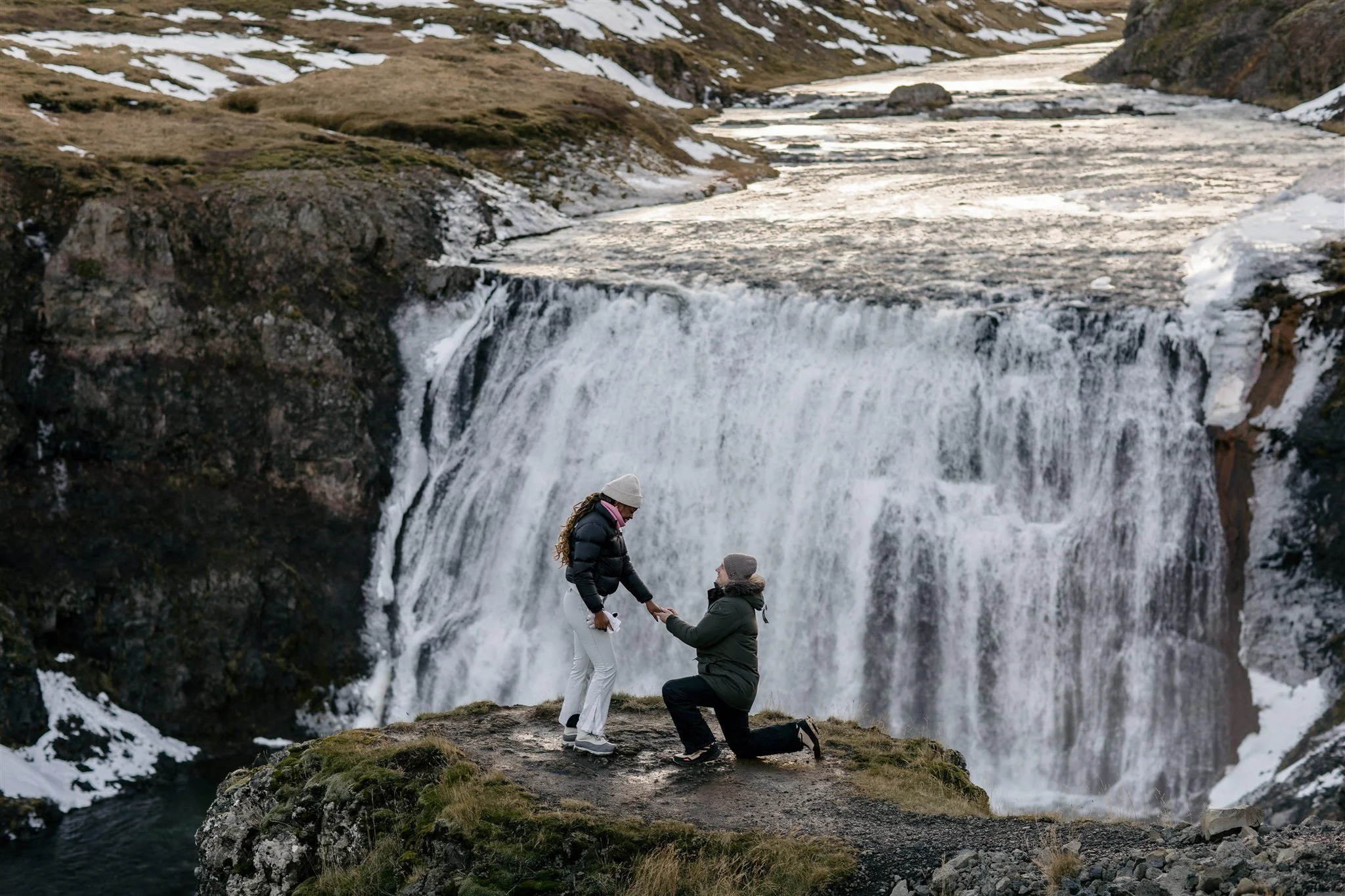 iceland proposal at a secluded waterfall in winter