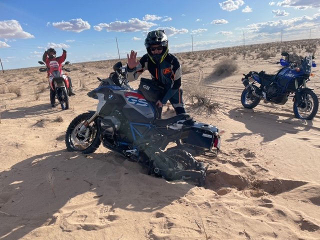 Motorcycle riding in deep sand.