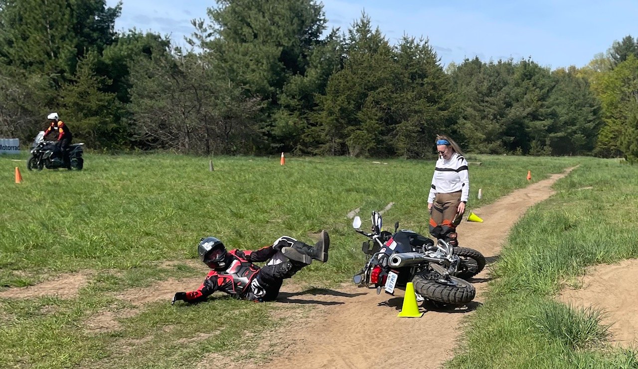  Rider falling off motorcycle on trail. 