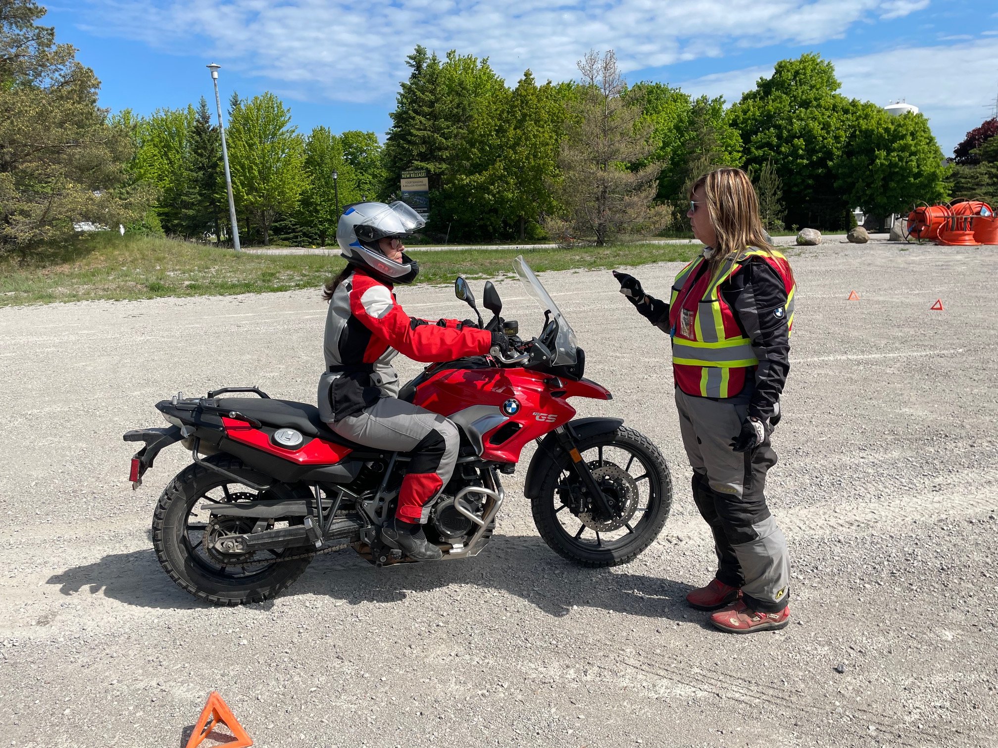  Motorcycle instructor talking to rider on motorcycle. 
