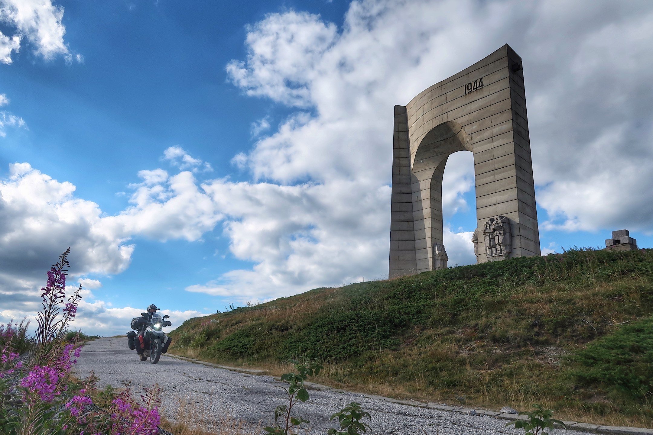  Motorcycle on road near war monument in Europe. 