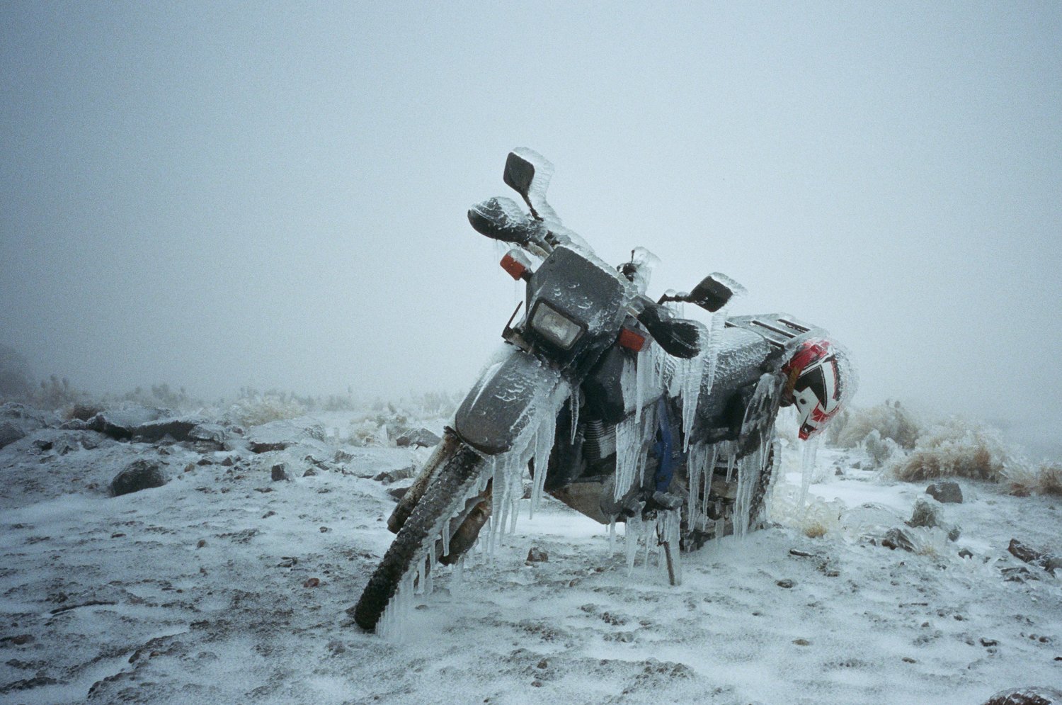  Motorcycle covered in icicles on a cold and stormy day. 