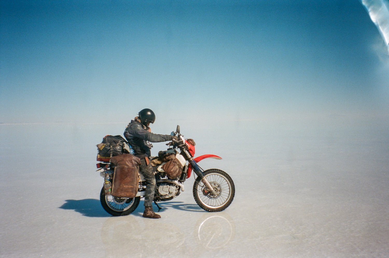  Motorcycle and rider stopped on ice covered lake. 