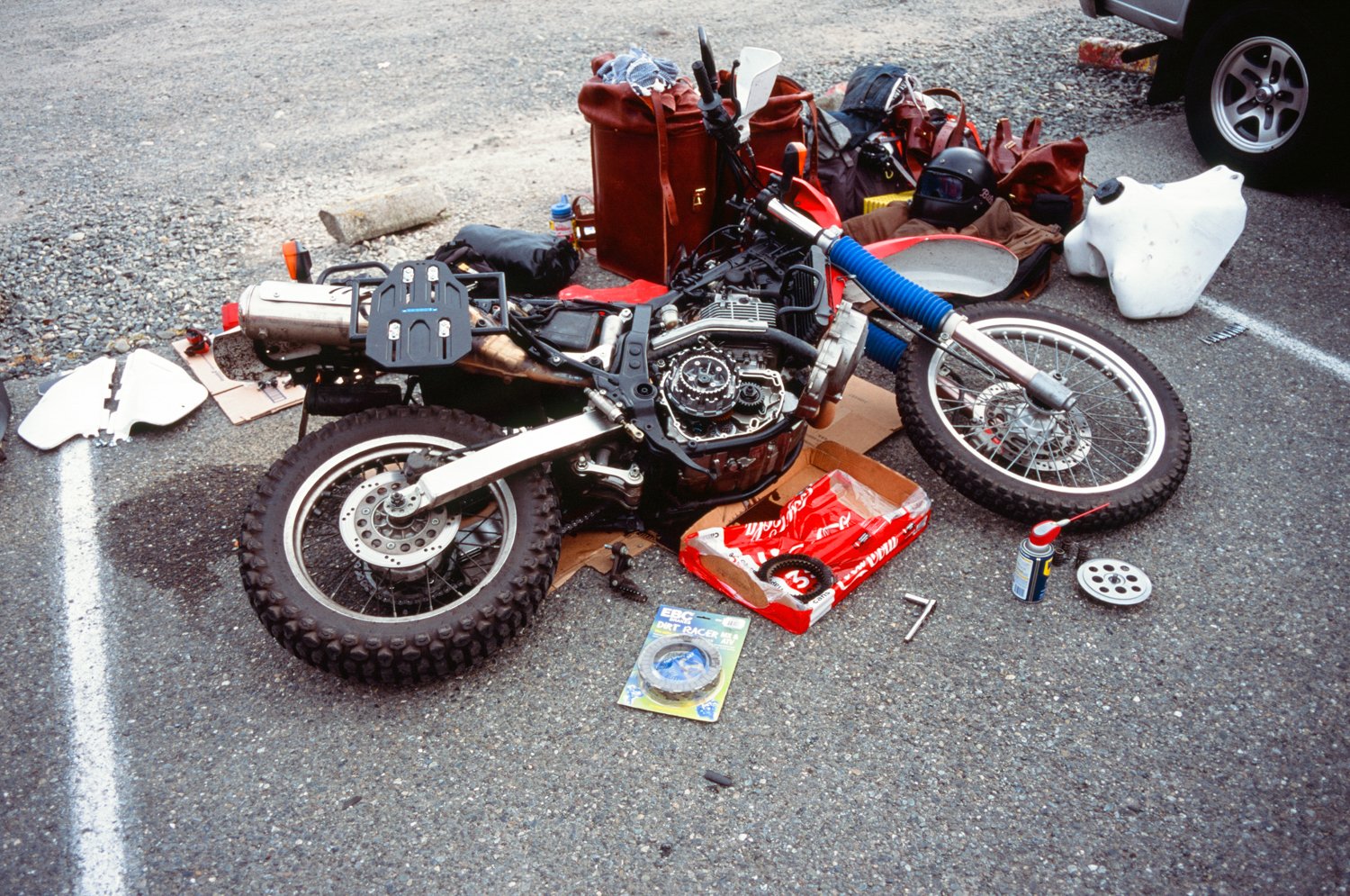  Motorcycle laying on ground being repaired. 