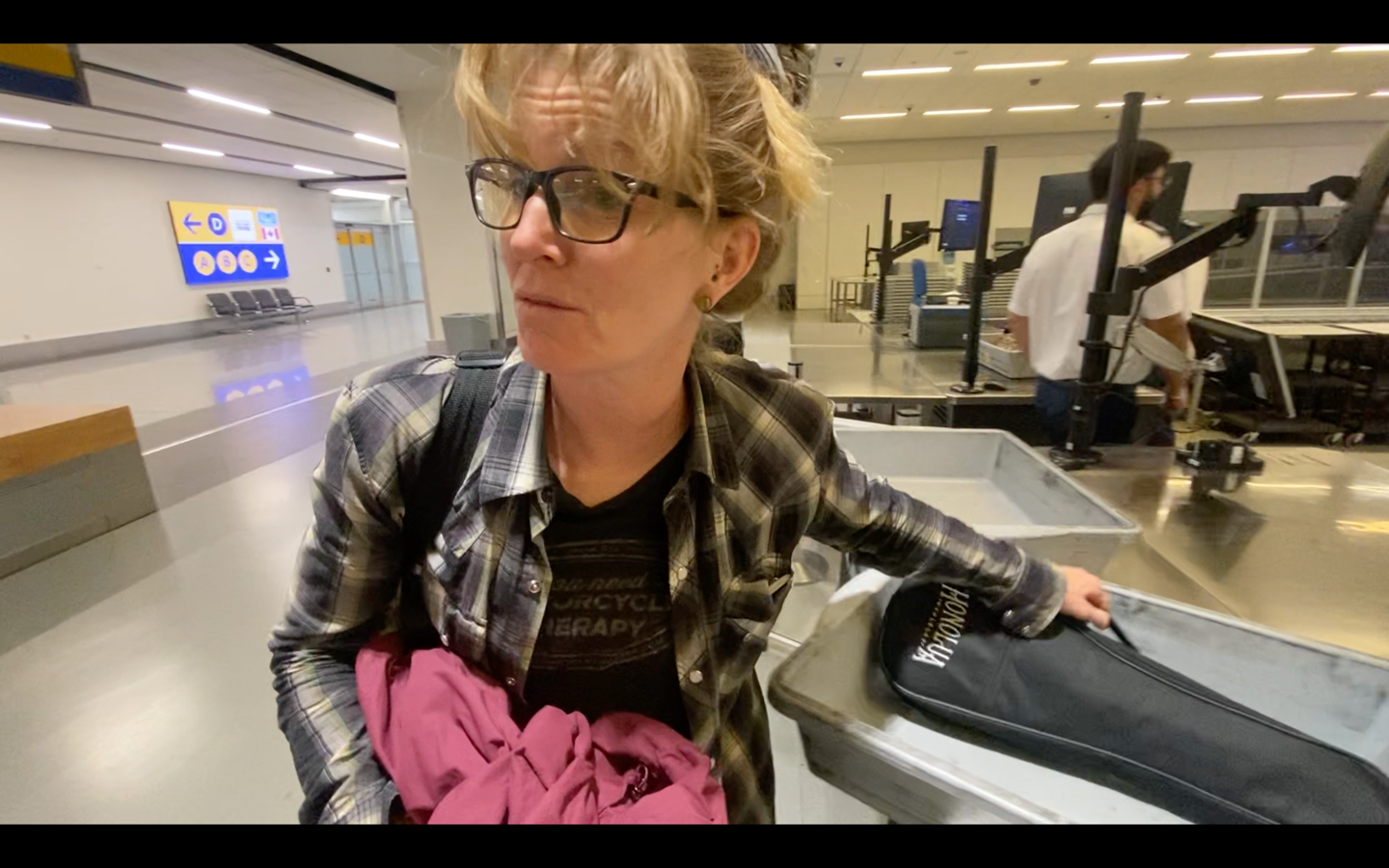  Elle collects her ukulele through security at Calgary airport.&nbsp; 