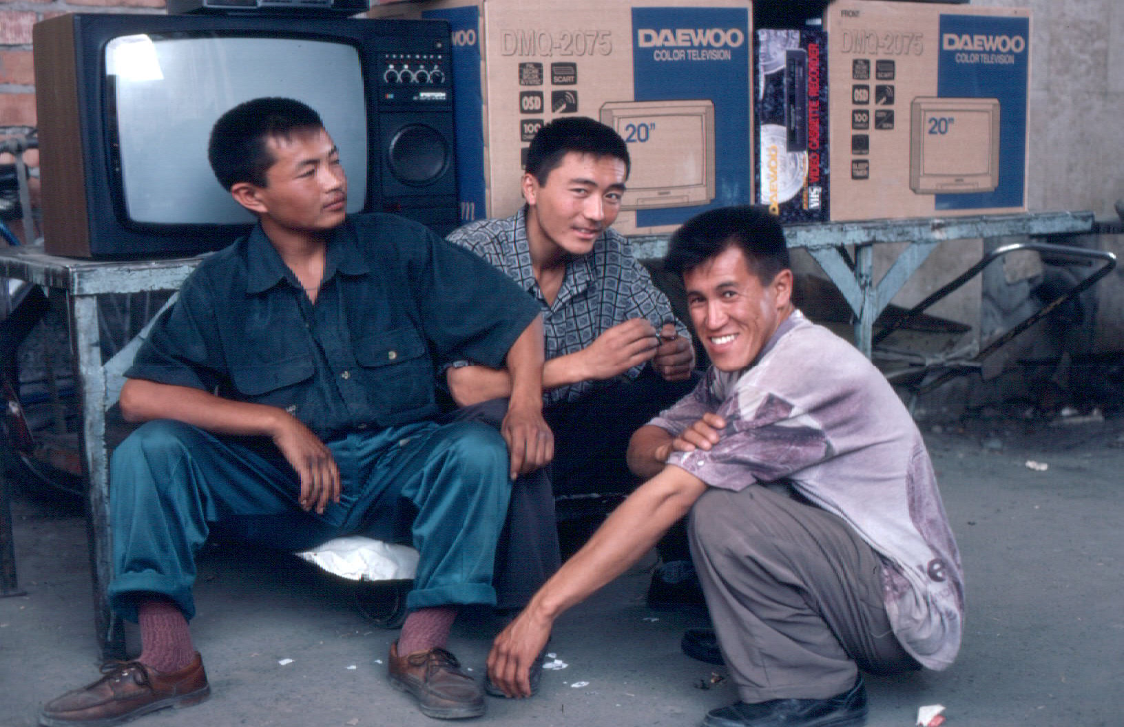 Buyer beware. The consumer electronics aisle at the bazaar in Osh, southern Kyrgyzstan, summer 1996. You'd better read the labels carefully. It's not a Panasonic, it's a Panascanic. And there's no 30-day return on those Daewoo TVs.