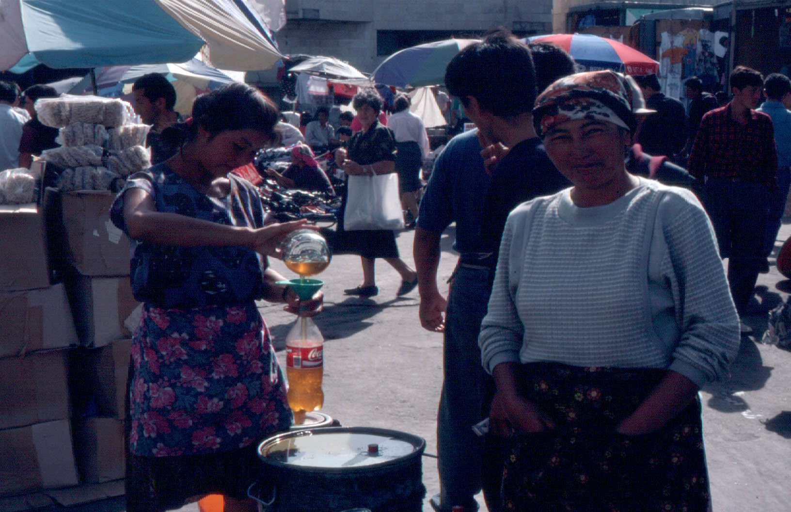 Recycling on the Osh bazaar--decanting cooking oil into plastic soda bottles