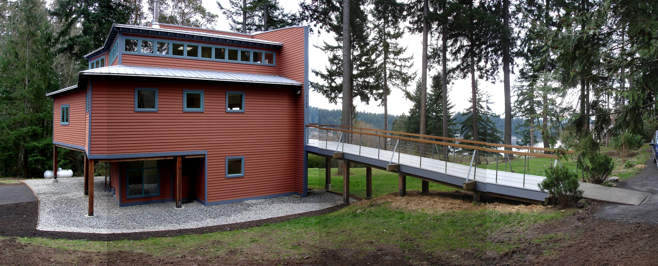 West Face- deck wraps around the southern curve to the front door.