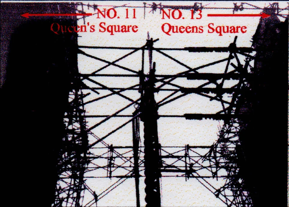 Overhead scaffolding (flying shores) obstructed piling equipment access to excavate the holes in the ground for the piers.