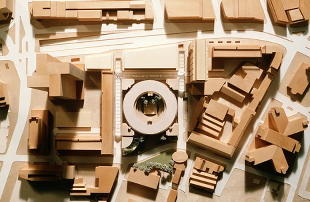Site Model: The site periphery is hedged round by existing buildings that make traditional building envelope a challenge. -Model by Arup Model Shop
