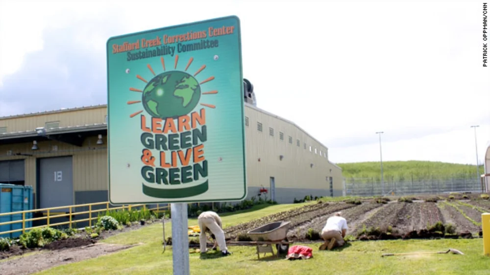 From CNN: The organic vegetables travel a short distance from the well-tended garden to the table where they are eaten. Waste is carefully picked through and recycled, saving thousands of dollars. The close-cropped lawns are maintained by push mowers to cut down on carbon emissions and gas expenses. This is not some new designer eco-hotel where the rich and environmentally conscious can be pampered free of guilt. It's a prison. At the The Corrections Center, a few yards from the garden where strawberries and cucumbers grow looms a tower where guards watch inmates, high-powered rifles at the ready. A jungle of razor wire surrounds the facility.