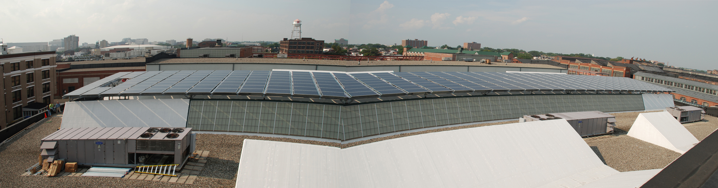 Photo 1: Panorama from Northwest showing the 103 kW Tilt Rack tied into existing building steel.